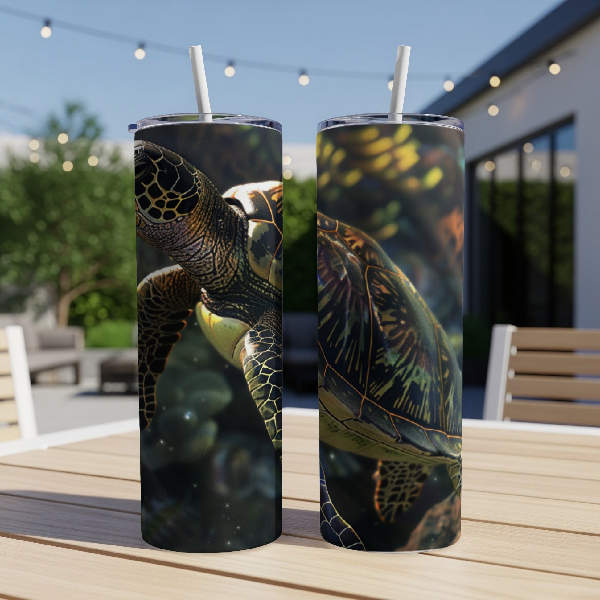Two tumblers with detailed sea turtle illustrations, set on a wooden table outdoors.