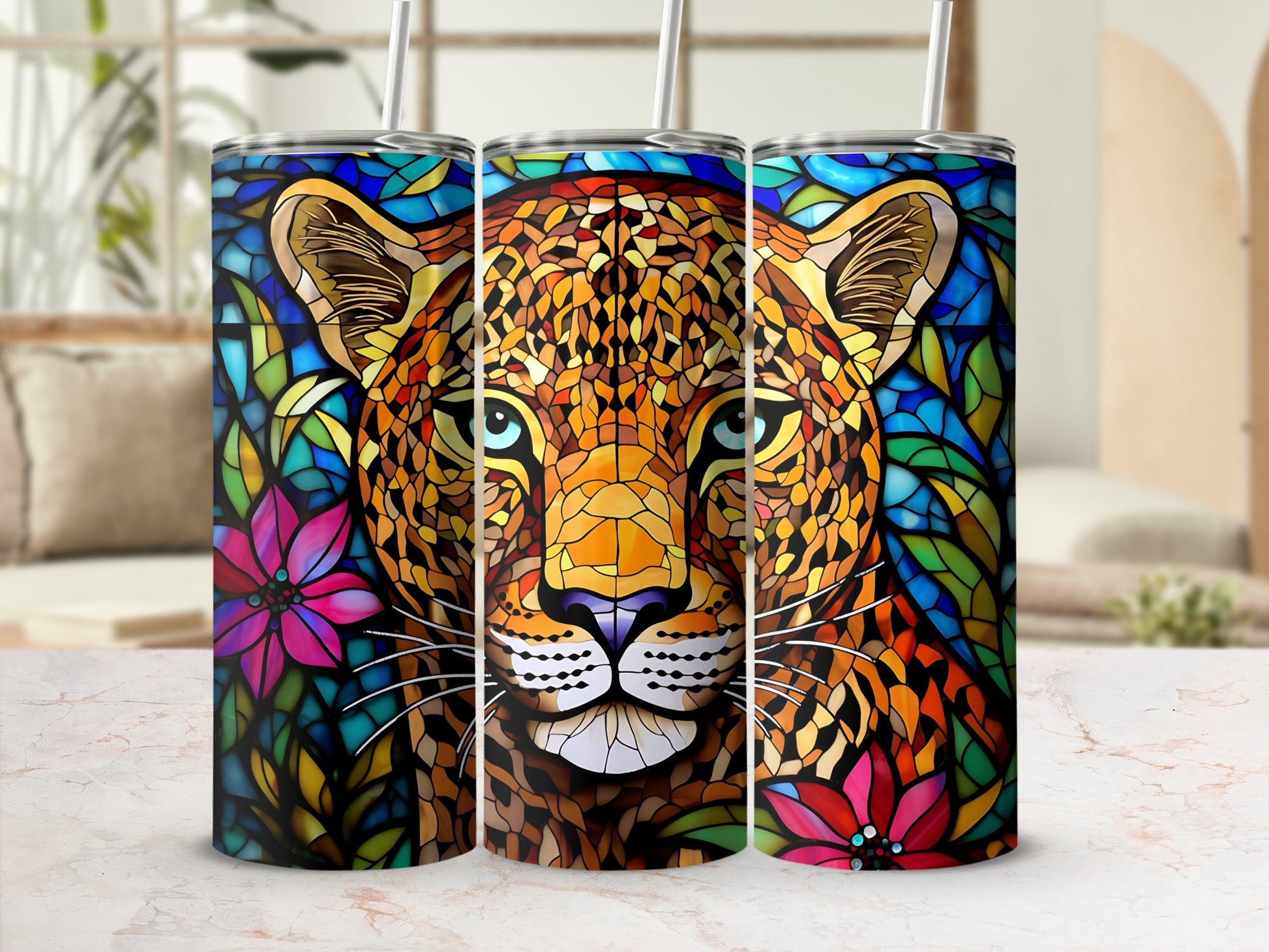 Leopard head with stained glass design on three tumblers with floral accents.