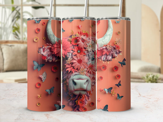 Pink tumbler with a floral cow and butterflies design.
