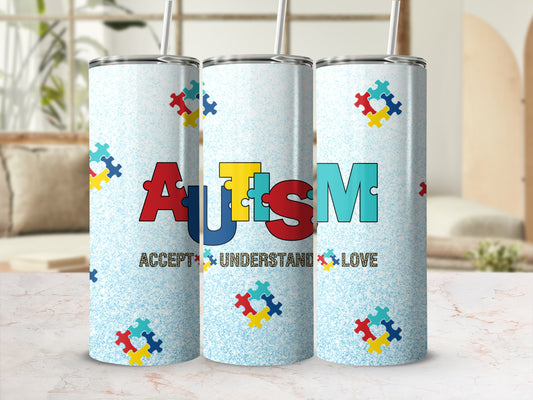 Tumbler with colorful autism puzzle pieces and text "Accept Understand Love."