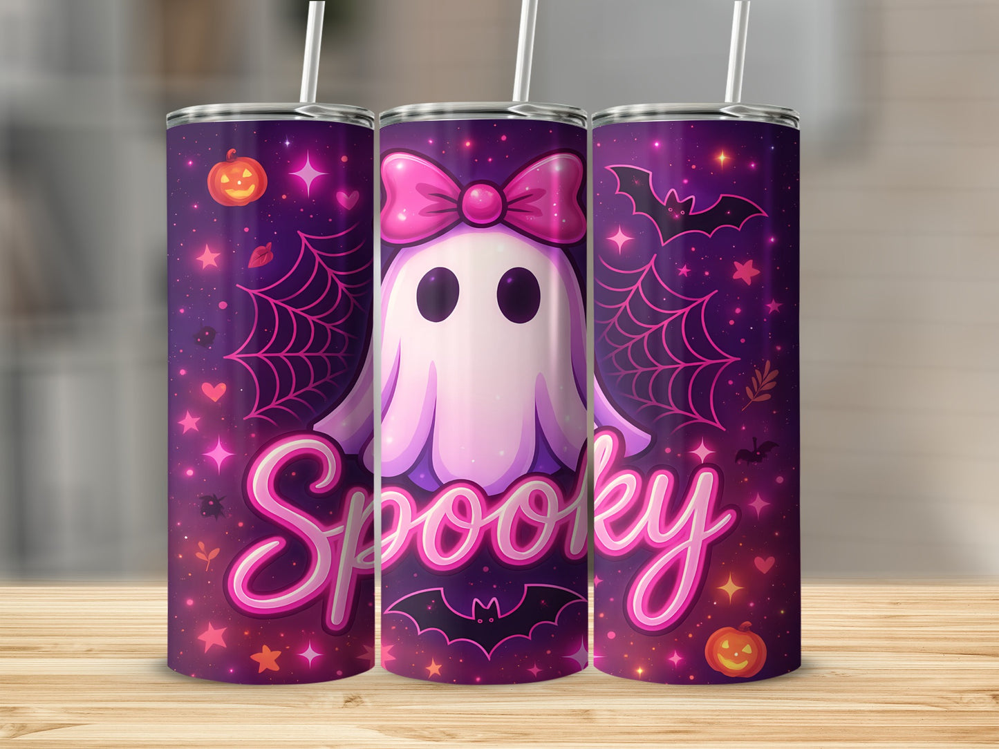 Three tumblers with a pink ghost, bow, bats, pumpkins, and "Spooky" text on a purple background.