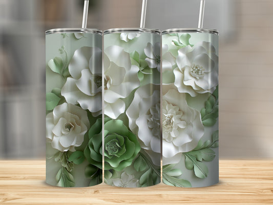 Three tumblers with white and green floral designs and straws.