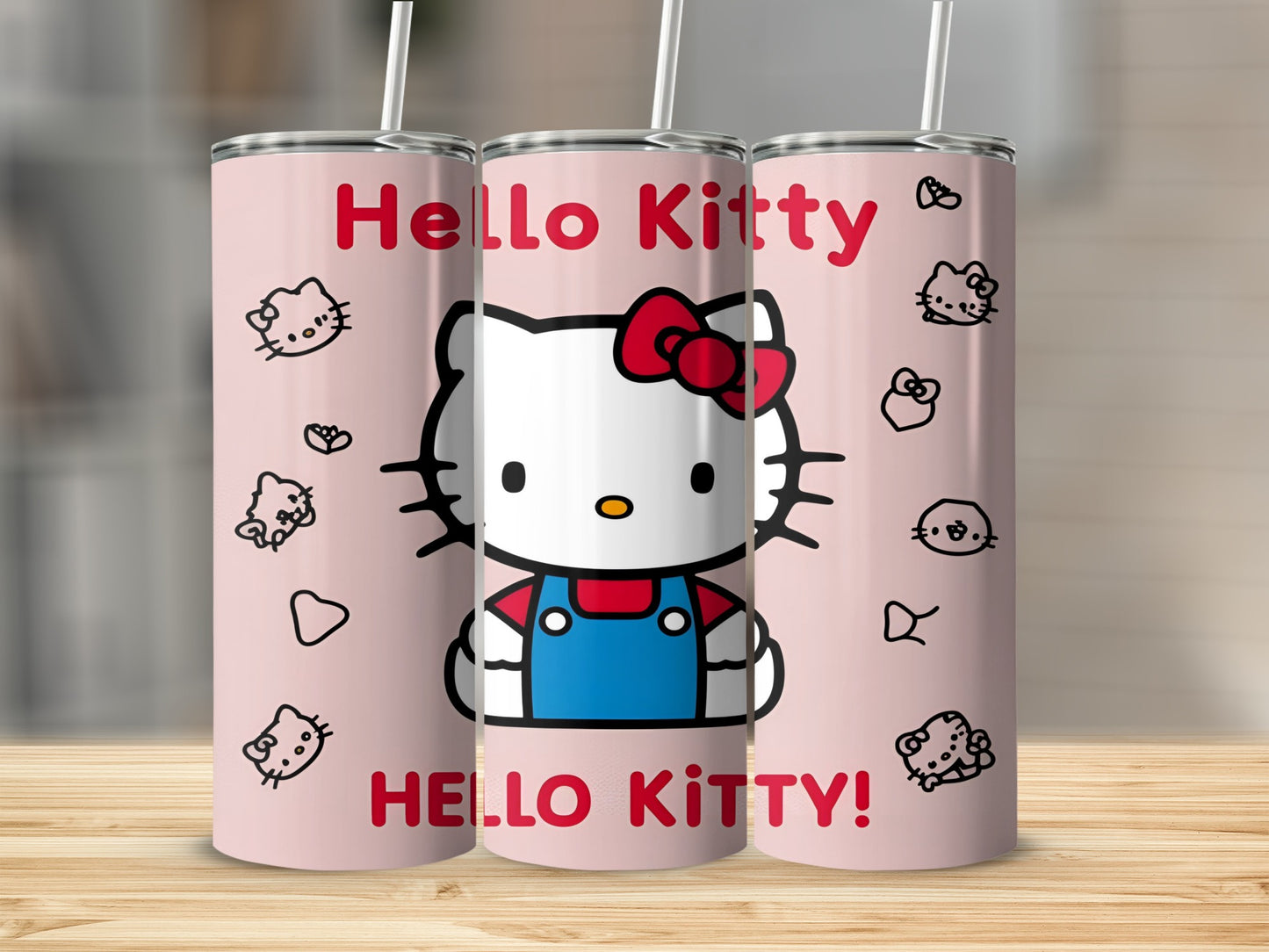 Hello Kitty tumbler with red bow and blue overalls on pink background.