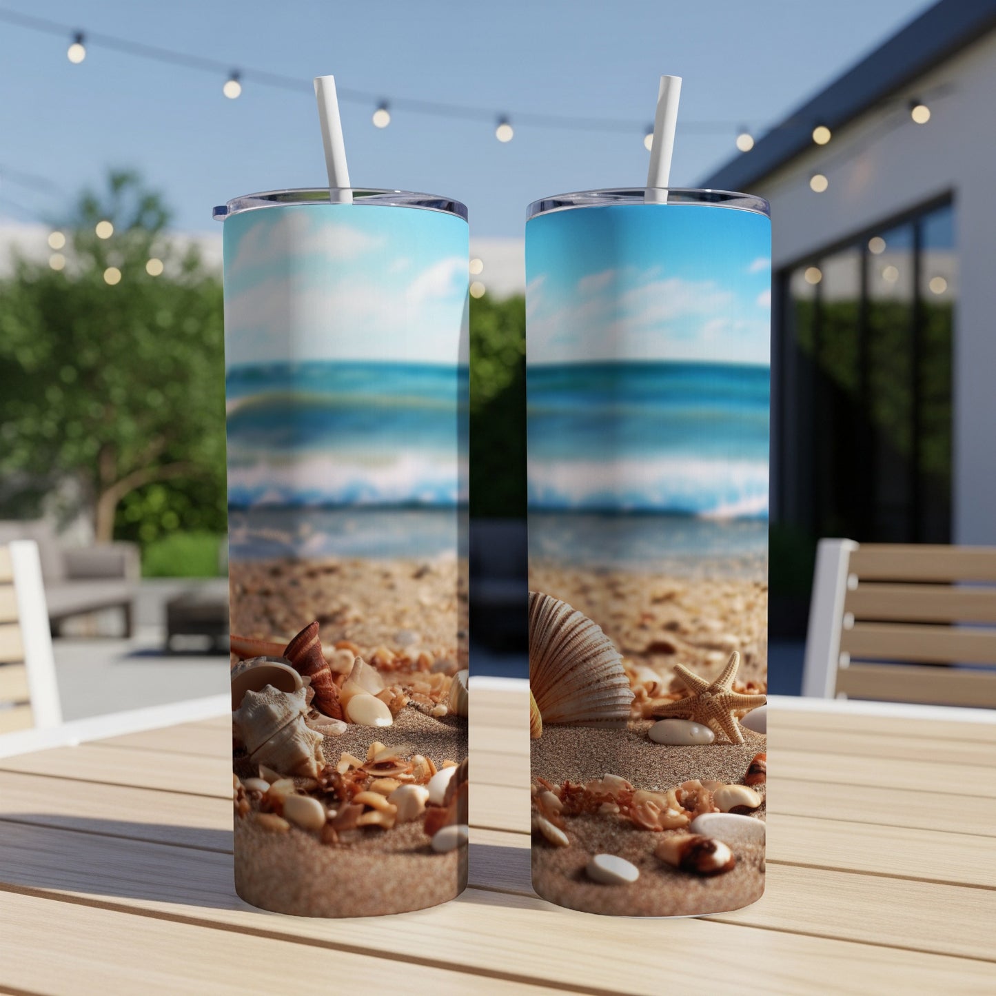 Two tumblers with a beach scene of shells and waves on a wooden table.