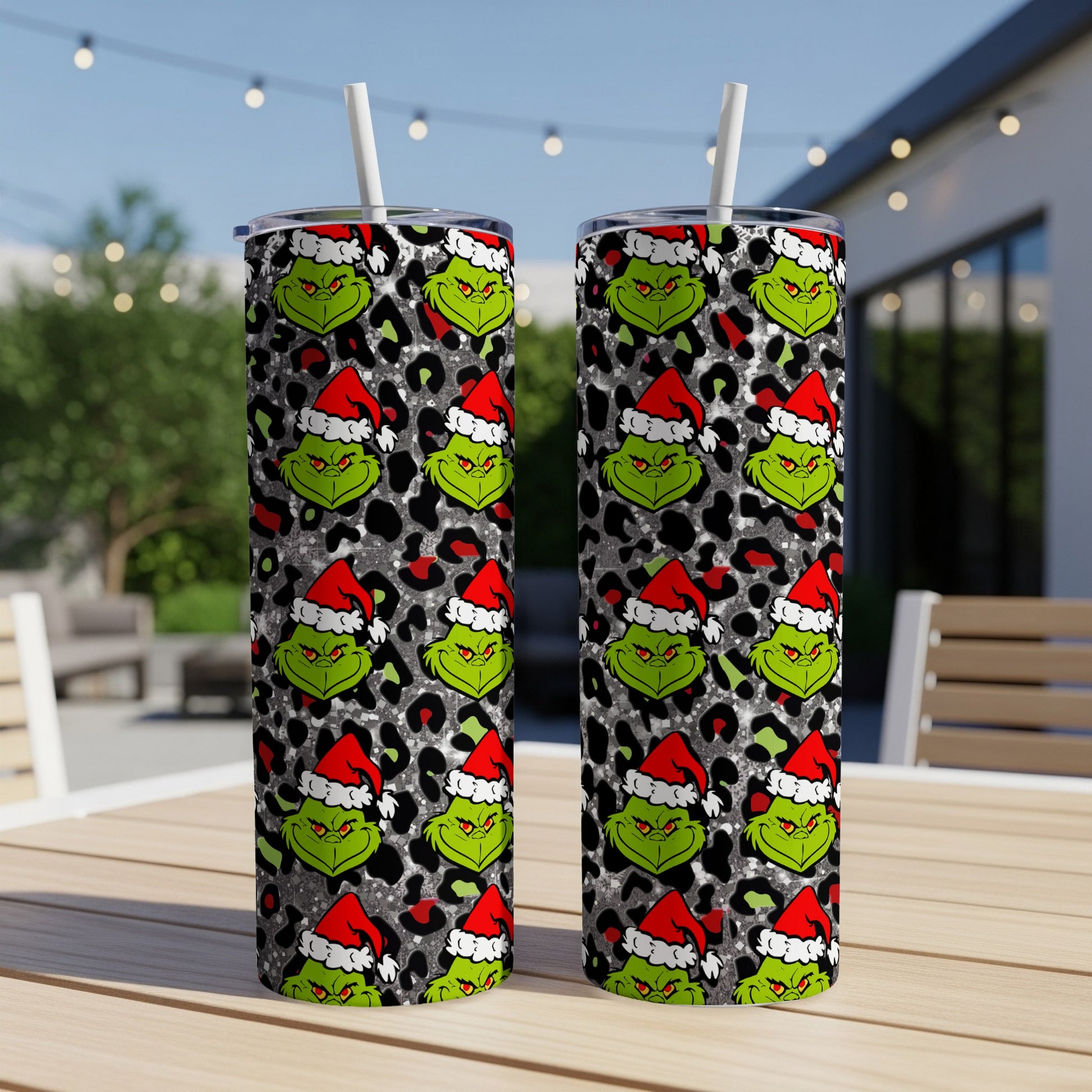 Grinch wearing Santa hat on leopard print background tumbler.
