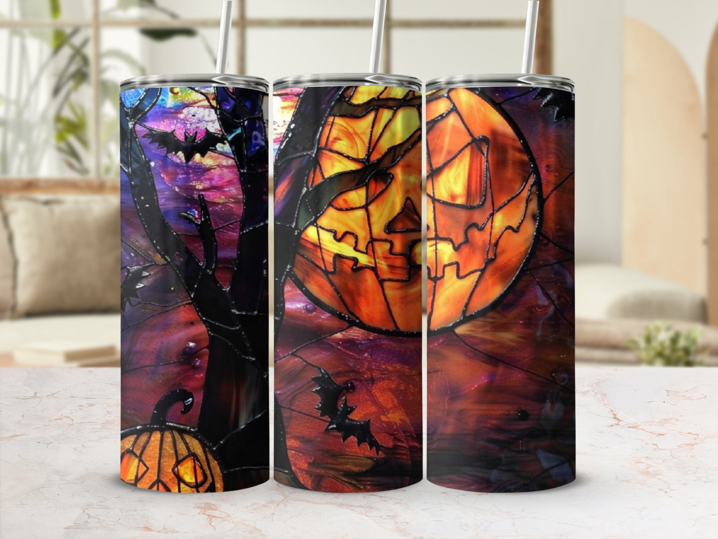 Three Halloween-themed tumblers with jack-o'-lanterns, bats, and stained-glass designs.