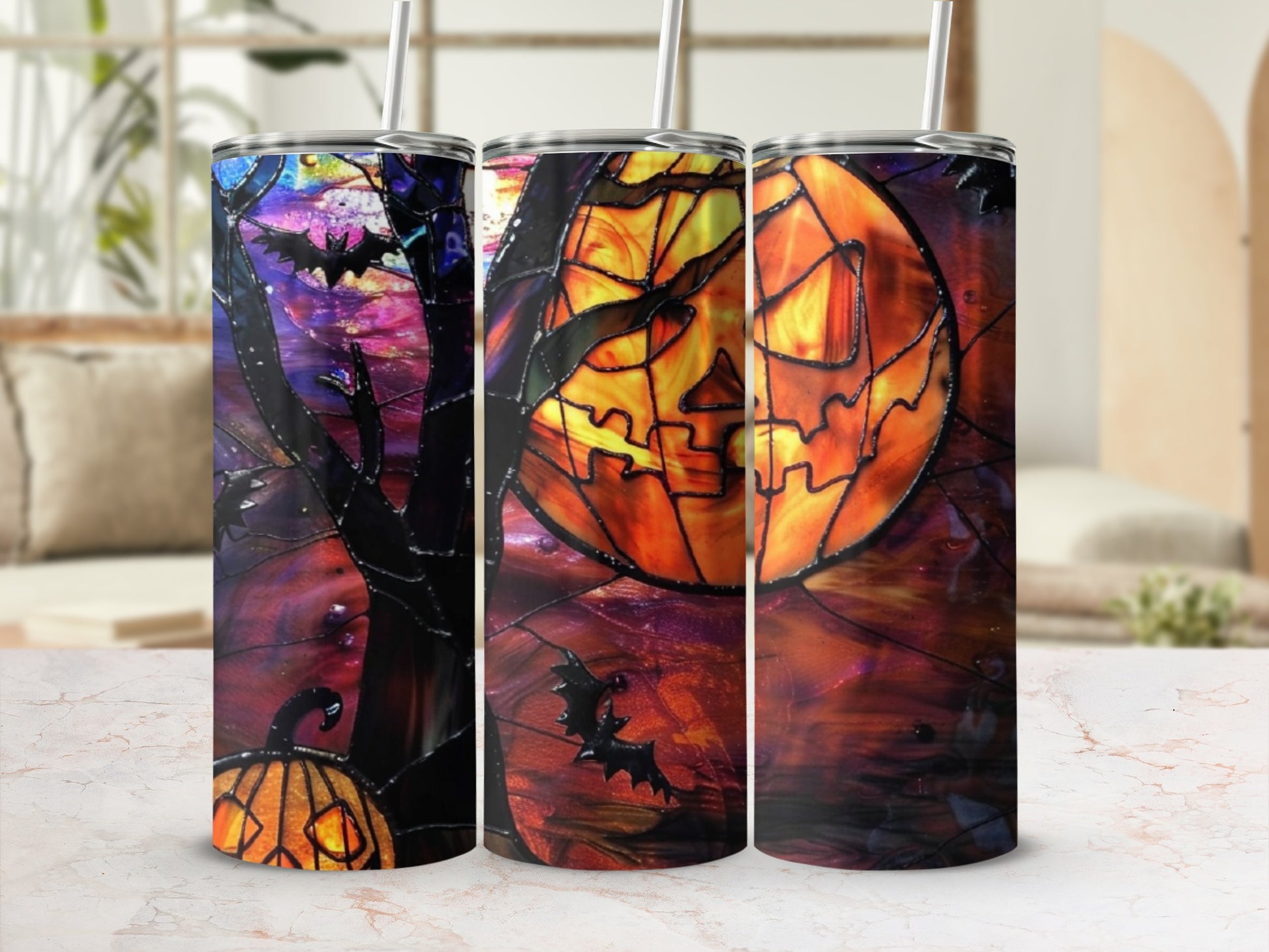 Three Halloween-themed tumblers with jack-o'-lanterns, bats, and stained-glass designs.