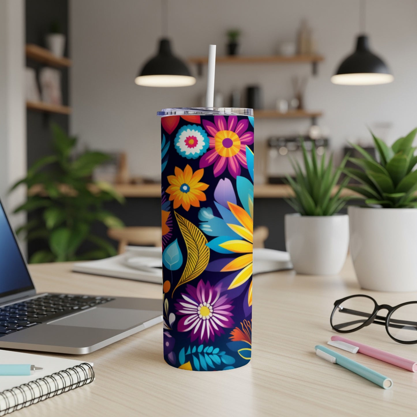 Tall tumbler with a colorful floral pattern and a white straw.