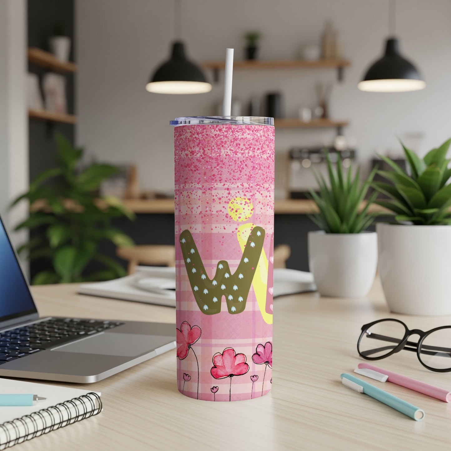 Pink tumbler with checkered pattern, flowers, and "W" design.