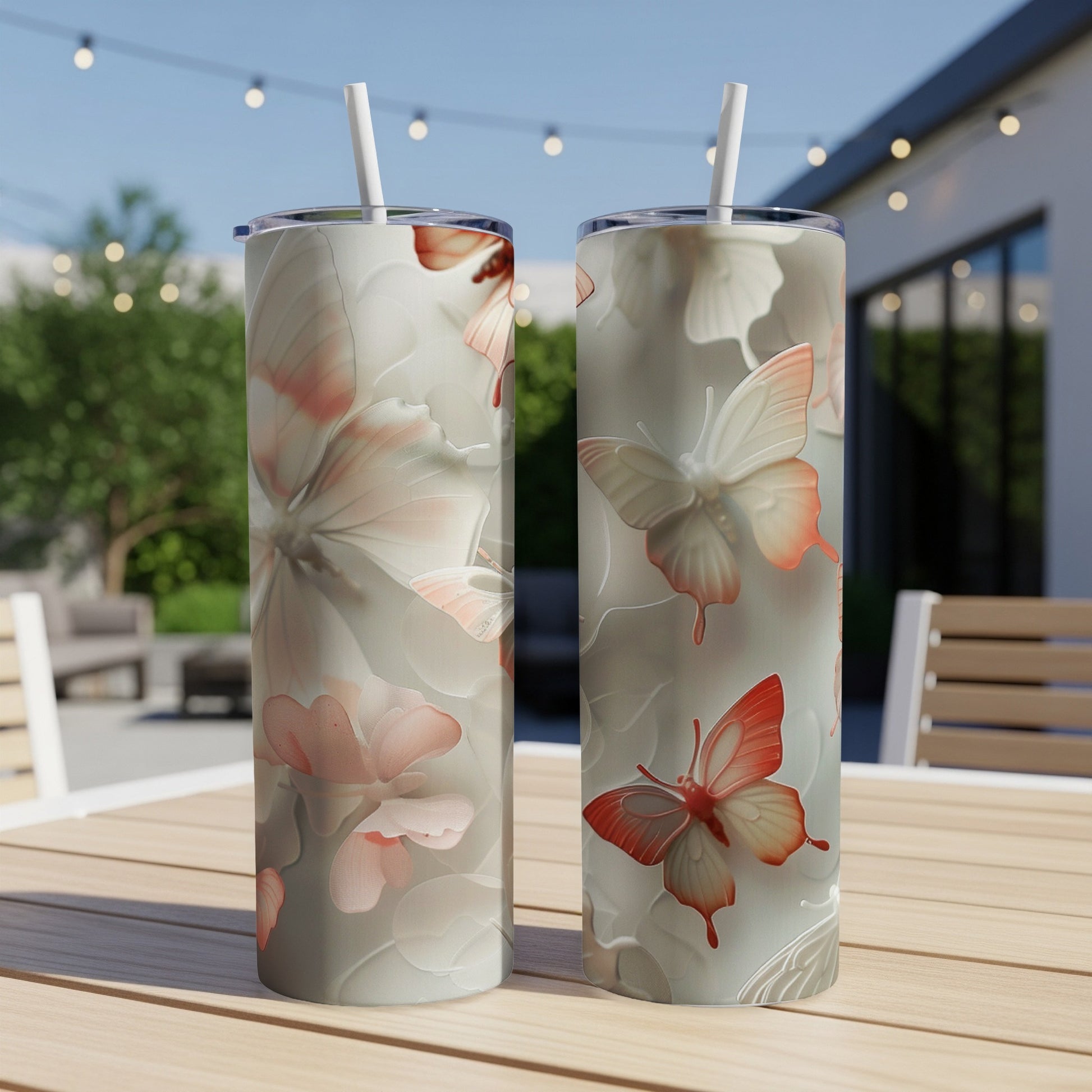 Two insulated tumblers with a butterfly and floral pattern.