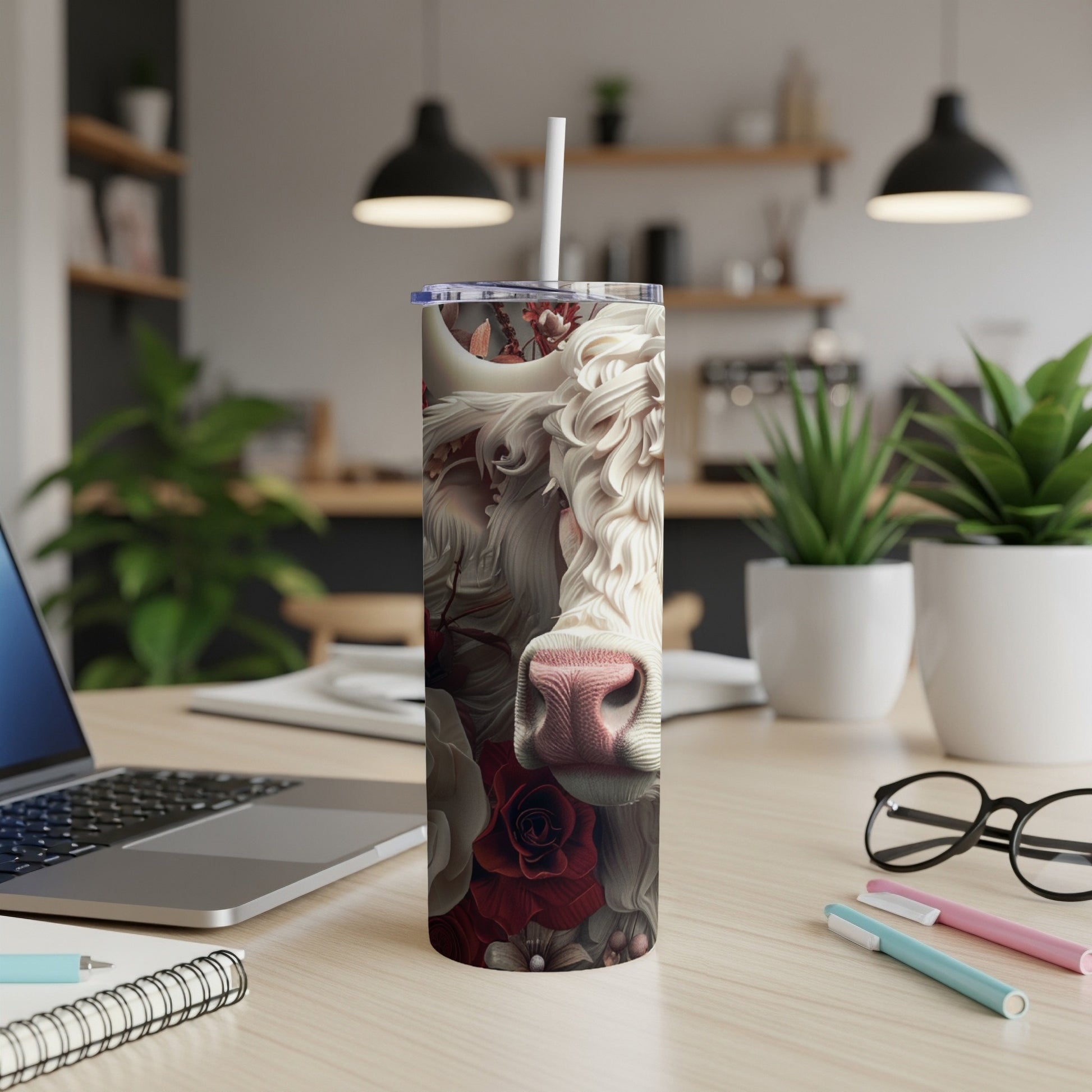 White cow with roses design on a stainless steel tumbler.
