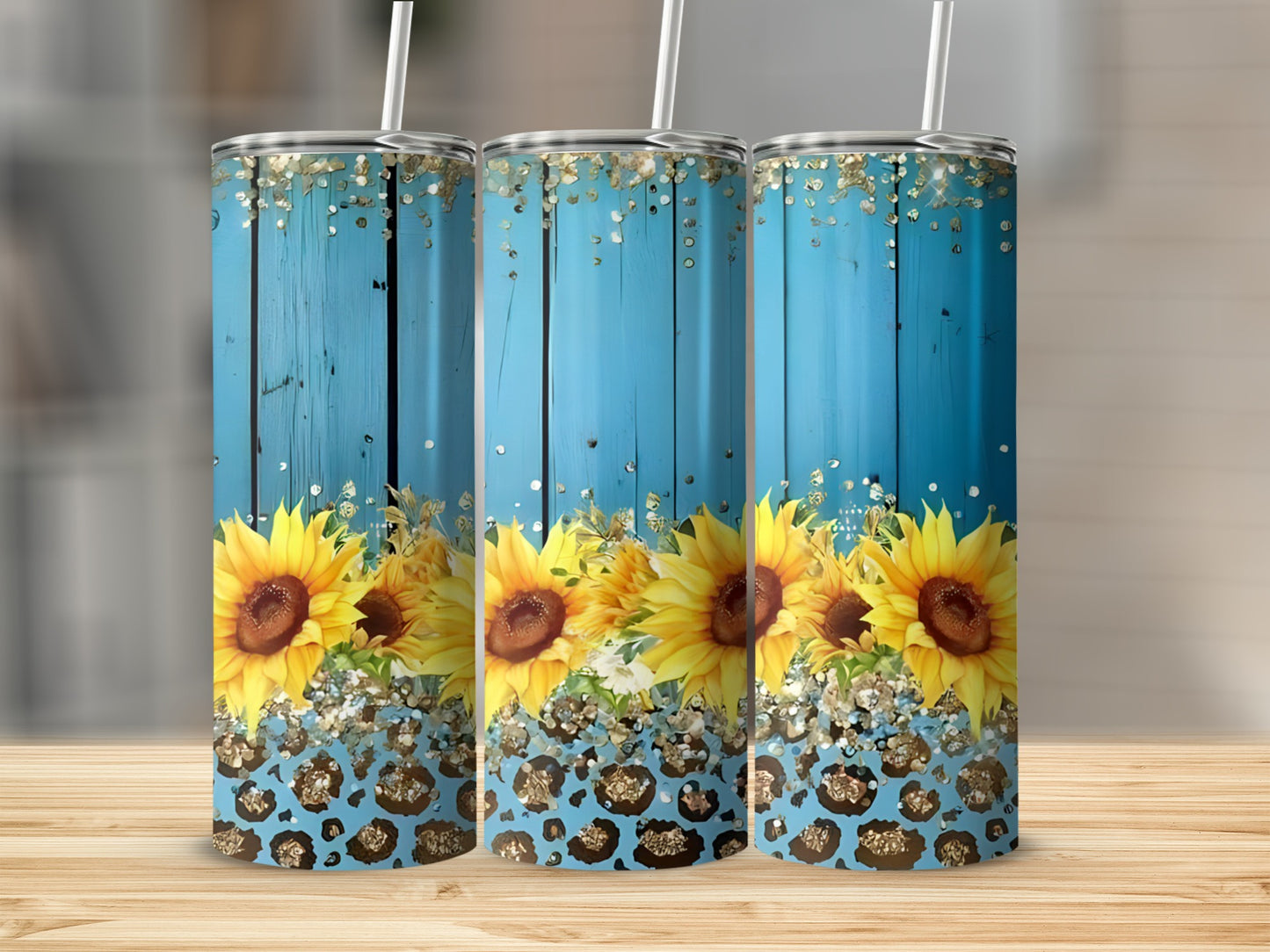 Three tumblers with sunflowers and leopard print on a wooden surface.