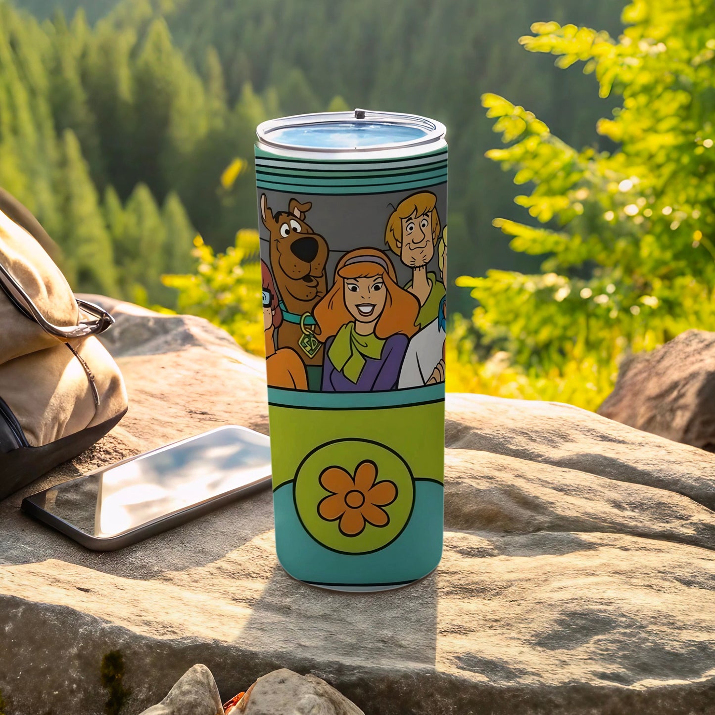 Scooby-Doo characters on a teal tumbler with a large orange flower design.