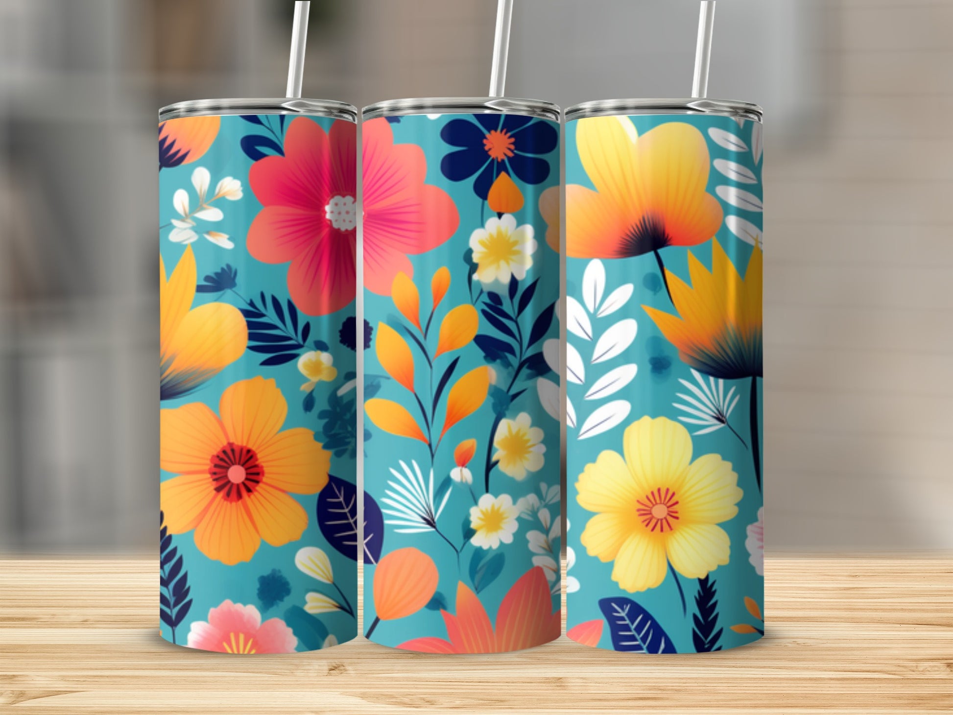 Three teal tumblers with vibrant floral patterns and straws.
