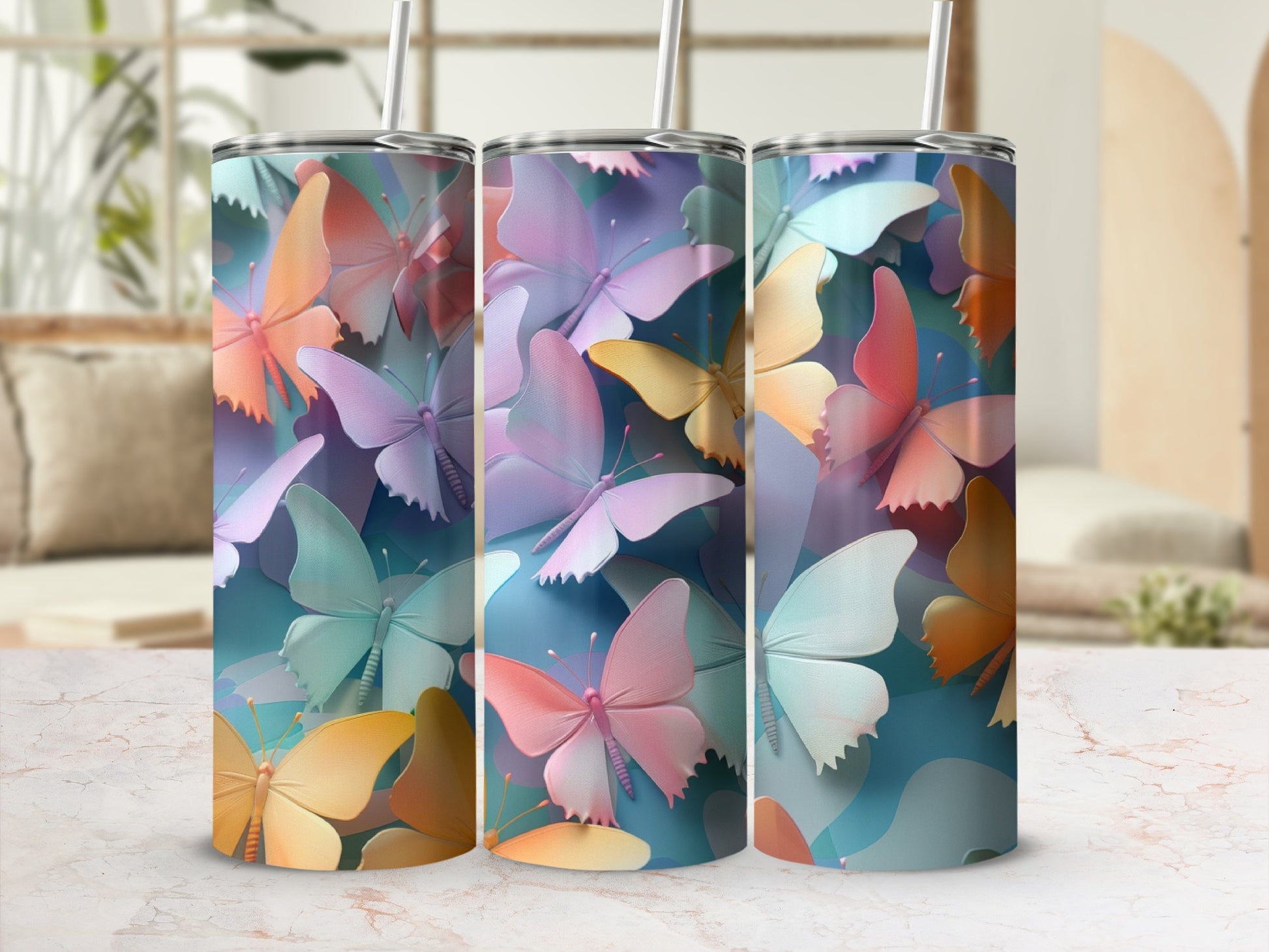 Three tumblers with pastel butterfly designs sit side-by-side.