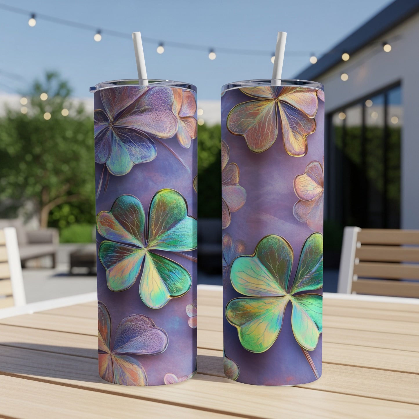 Two iridescent shamrock tumblers on a wooden table outdoors.