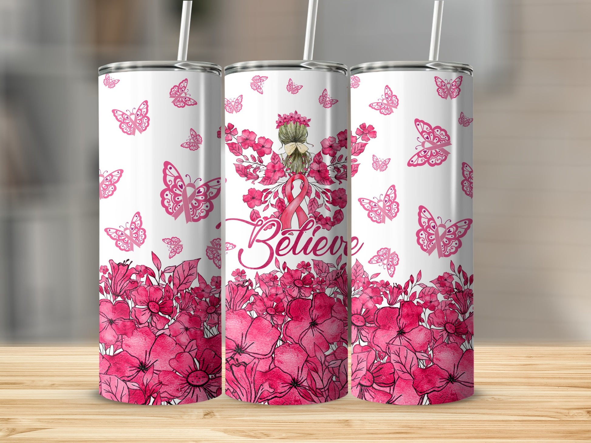 Pink floral design with butterflies and the word "Believe" on a tumbler.