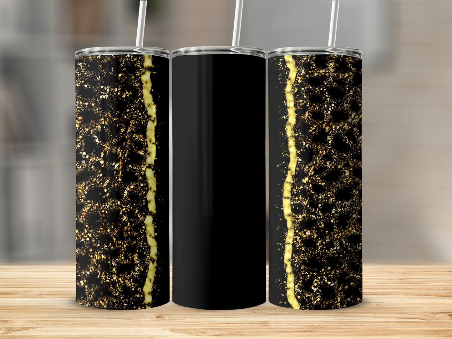 Black tumbler with gold glitter and vertical stripe design.