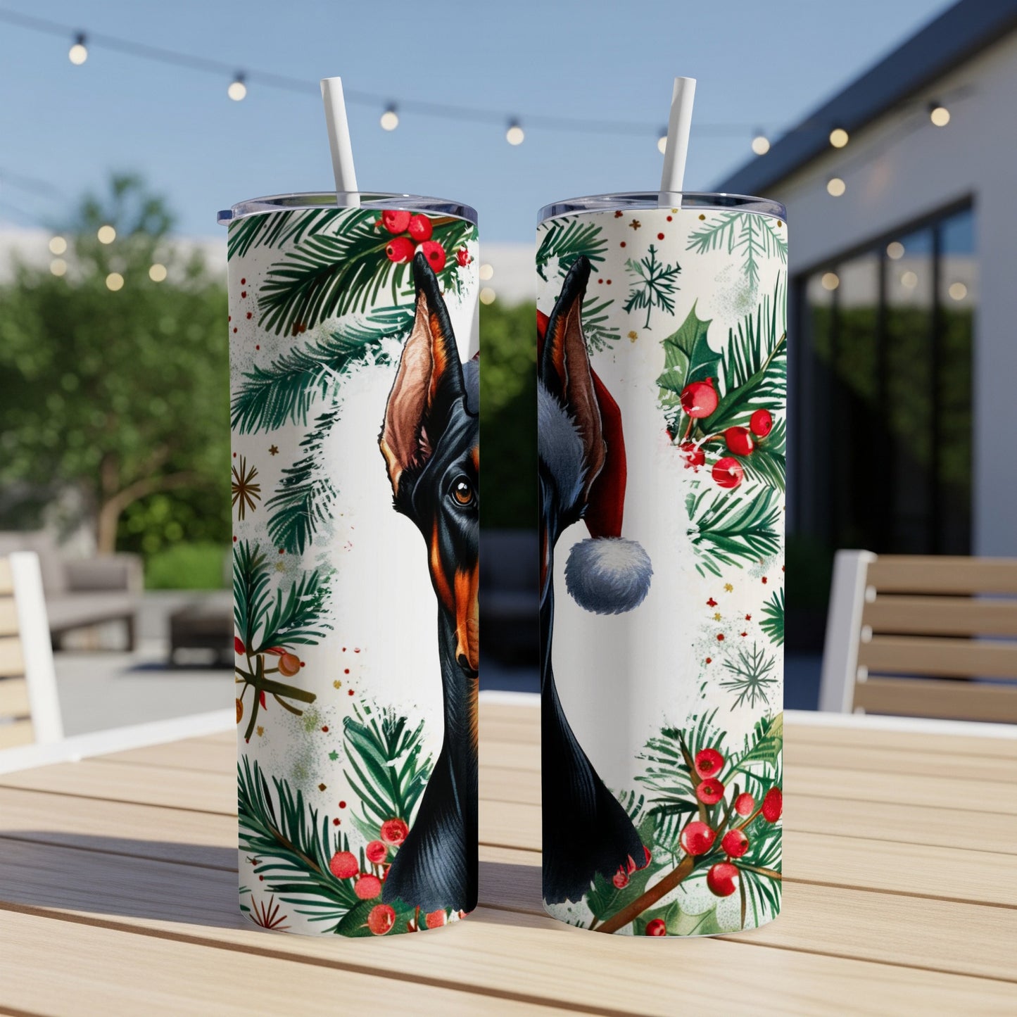 Two tumblers featuring a Doberman in a Santa hat with festive greenery.