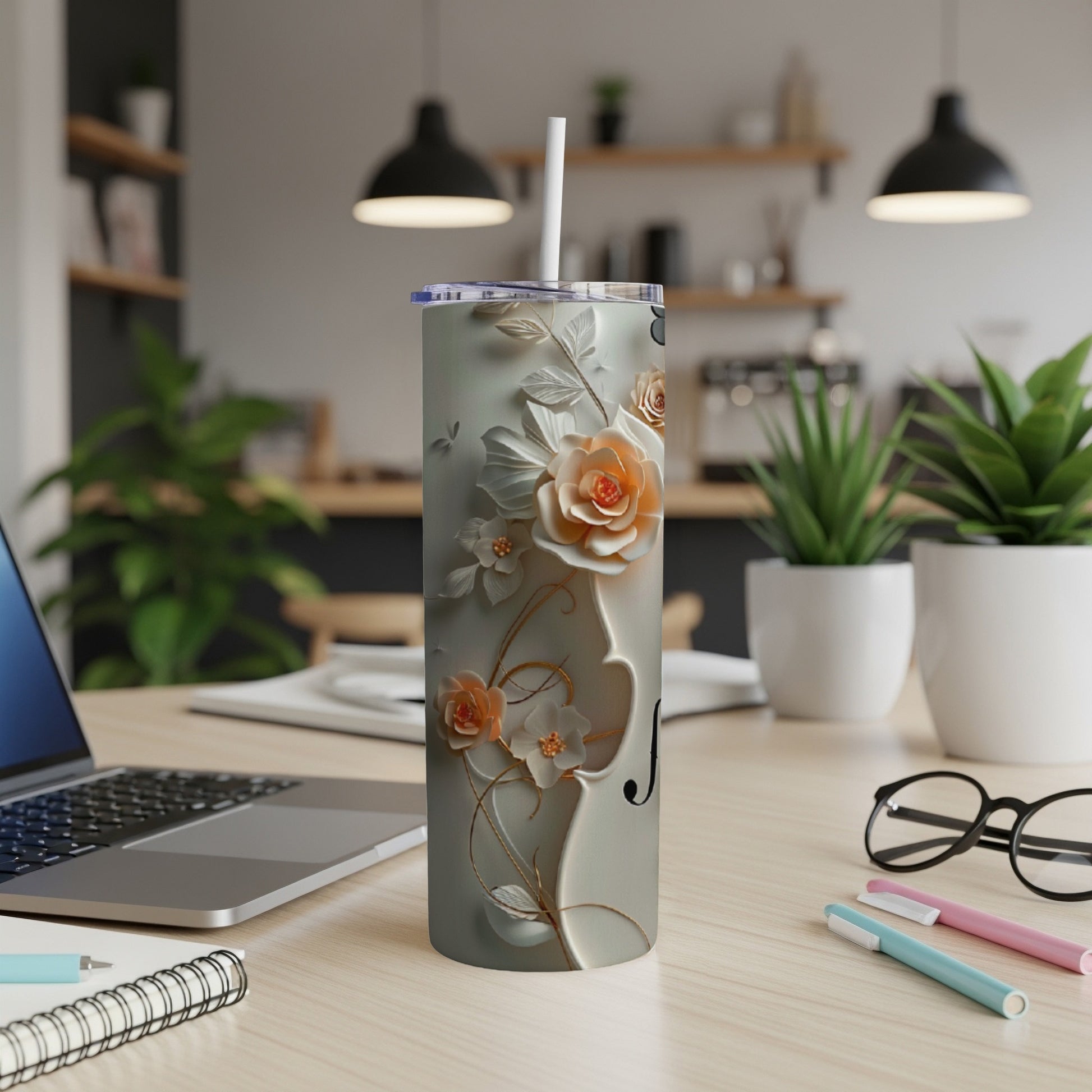 Gray tumbler with delicate orange floral design and a white straw.