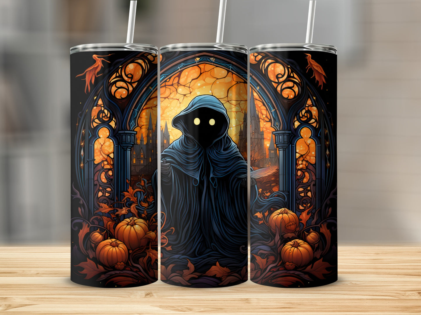 Three tumblers with a dark, hooded figure, pumpkins, and autumn leaves design.
