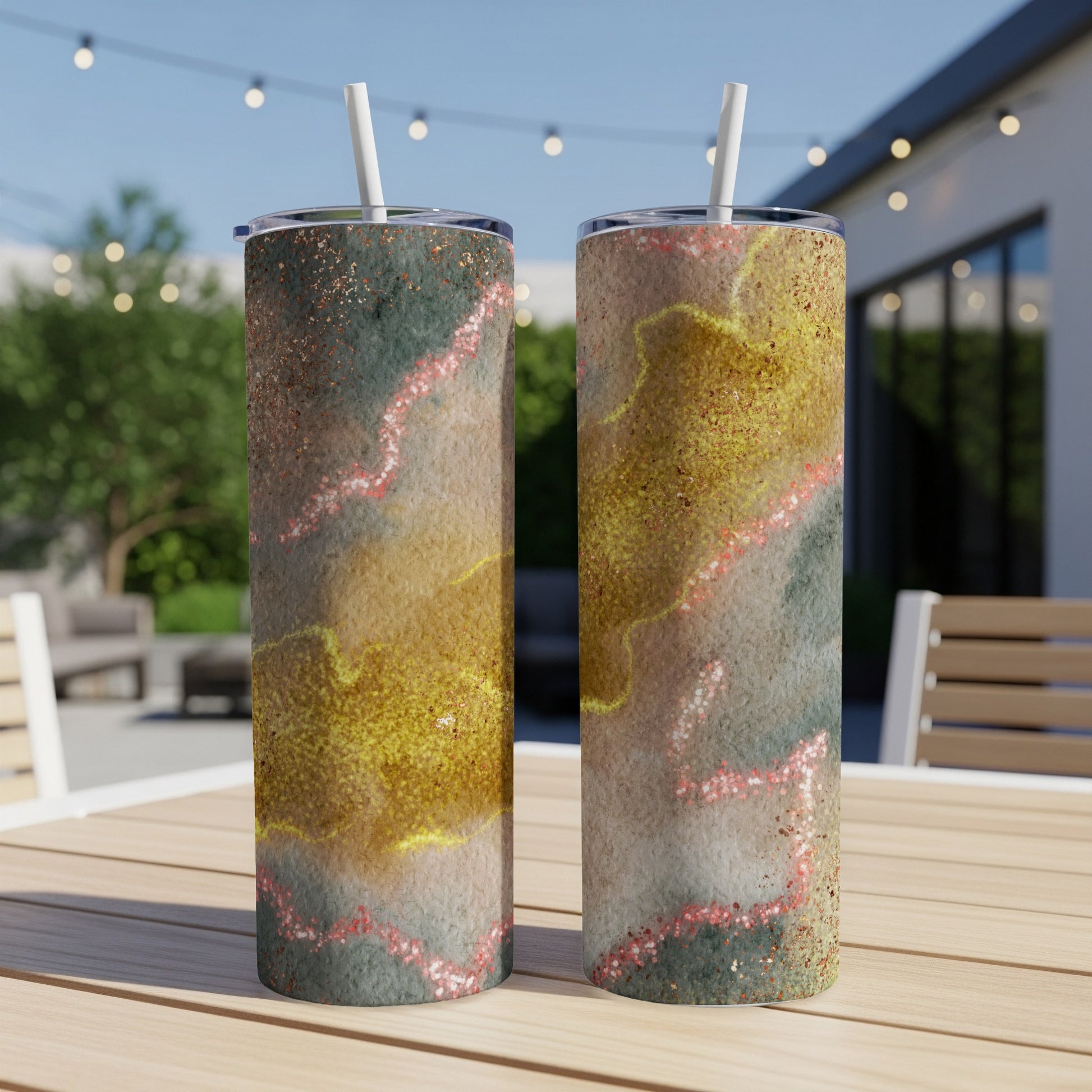 Two tall tumblers with abstract, glittery gold and pink marbled design.
