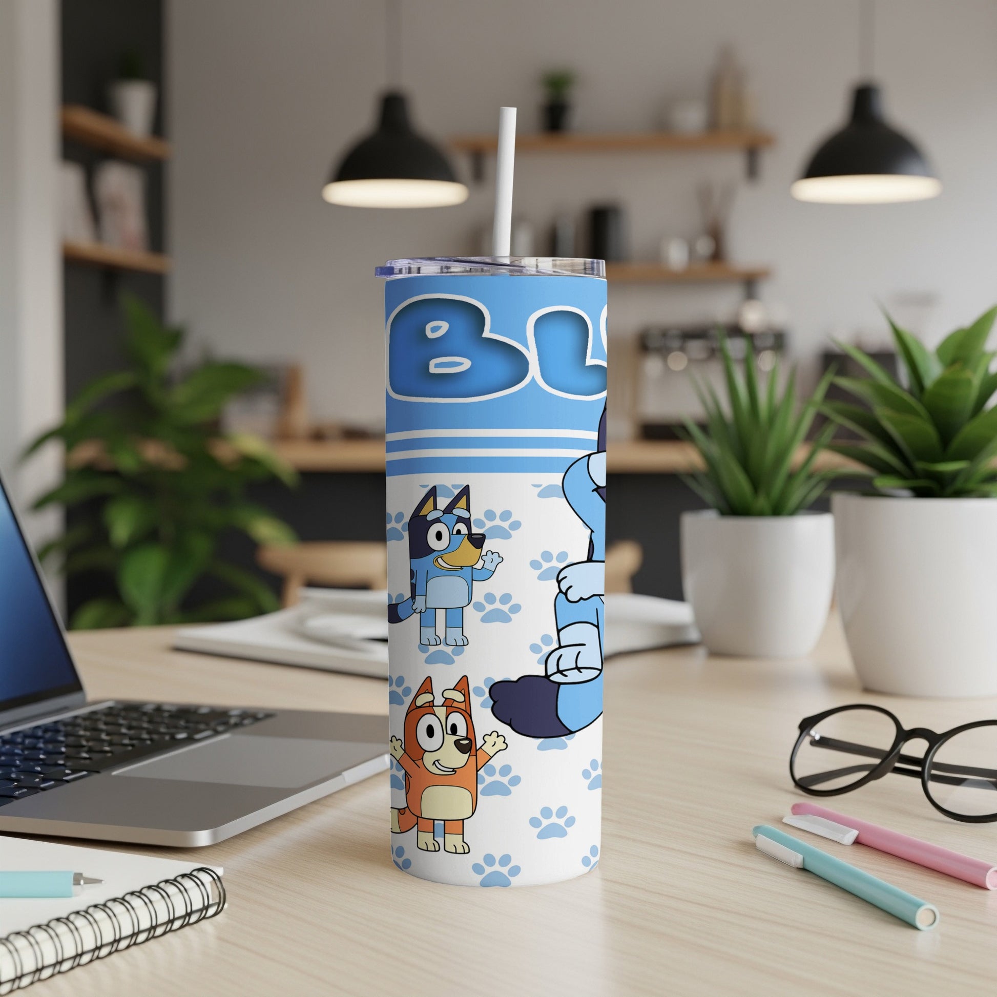 Bluey and Bingo characters on a blue tumbler with paw prints and "BLUEY" text.
