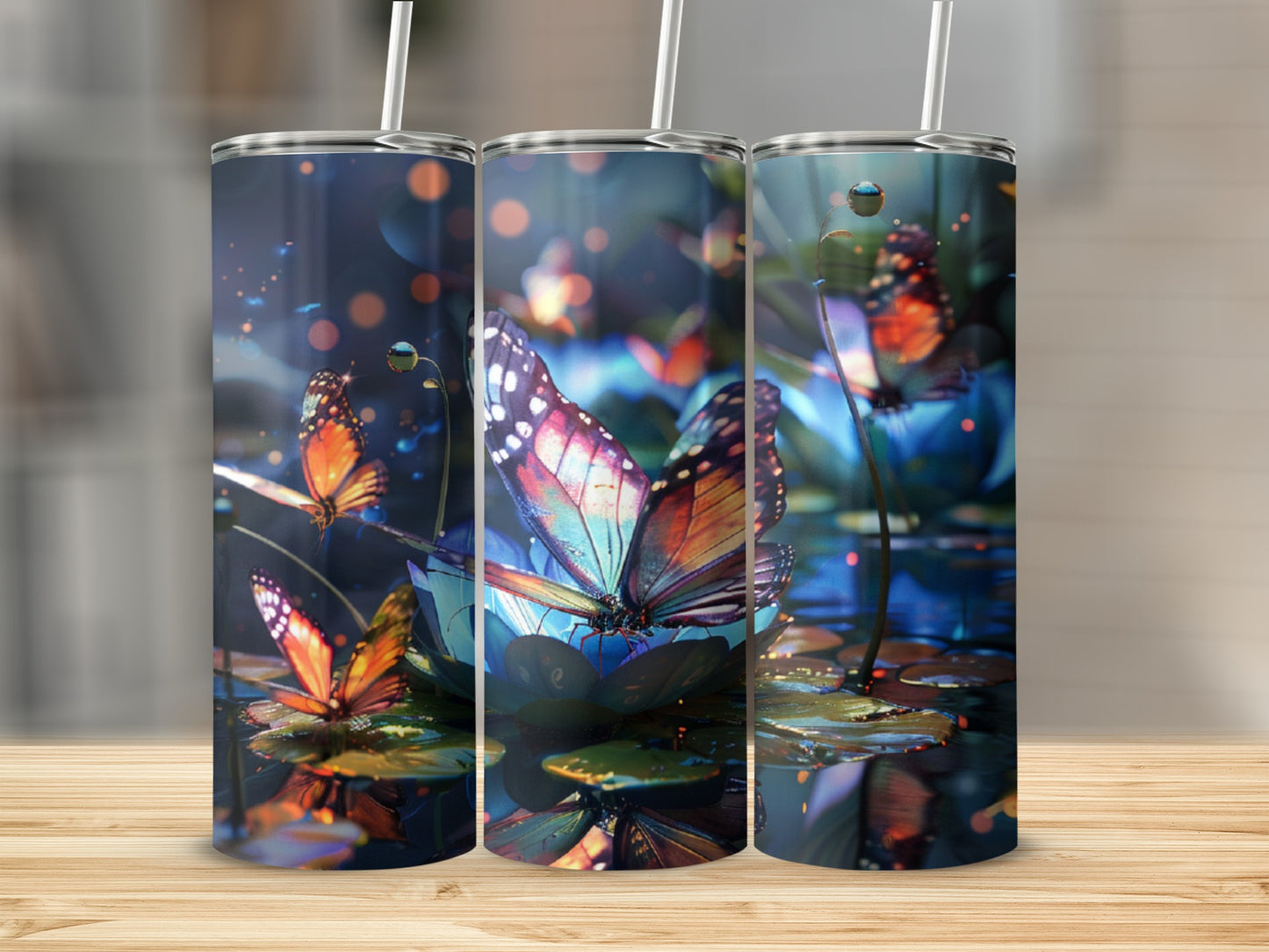 Three tumblers featuring colorful butterflies on a lily pad.