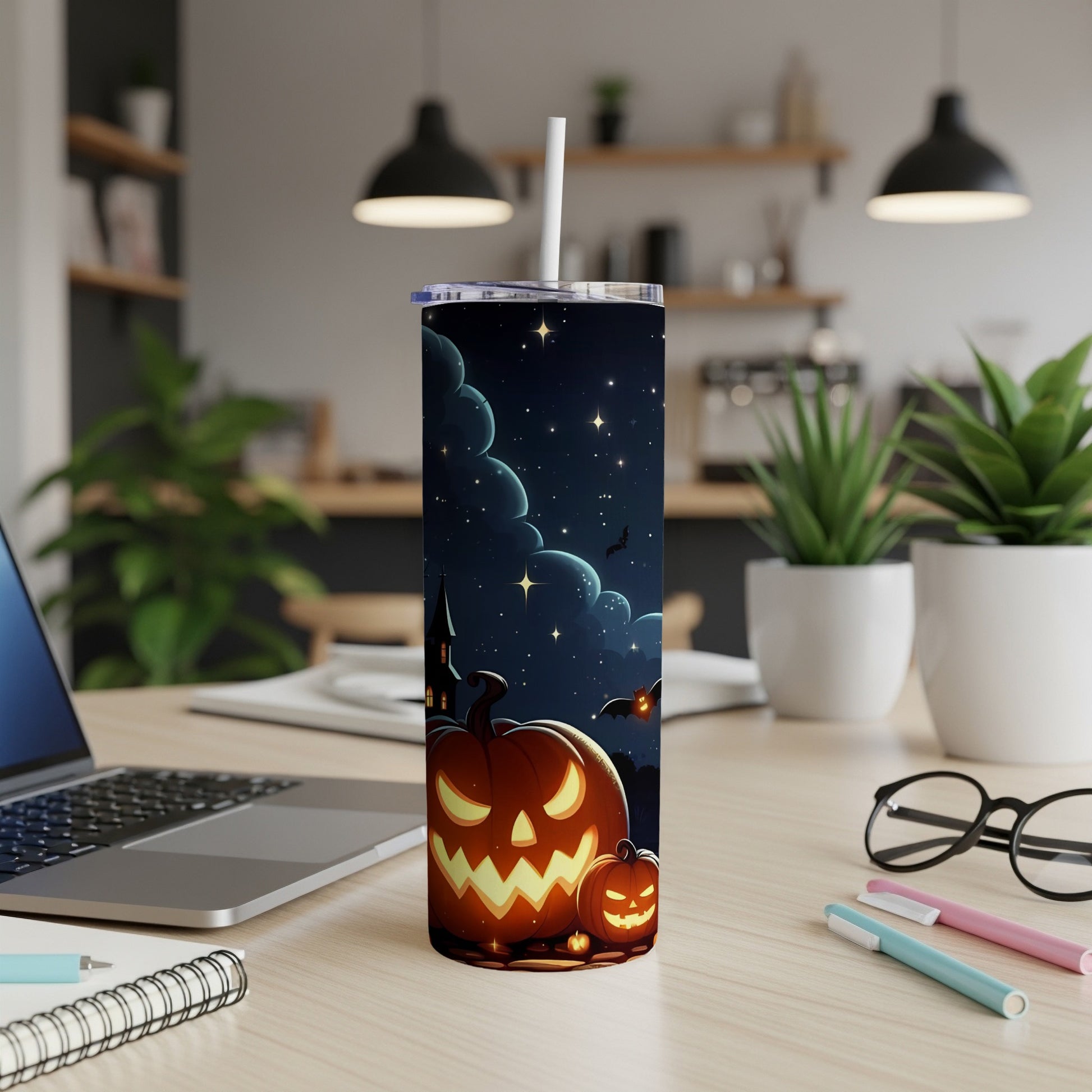 Tumbler with a spooky Halloween scene of glowing pumpkins and bats against a starry night sky.