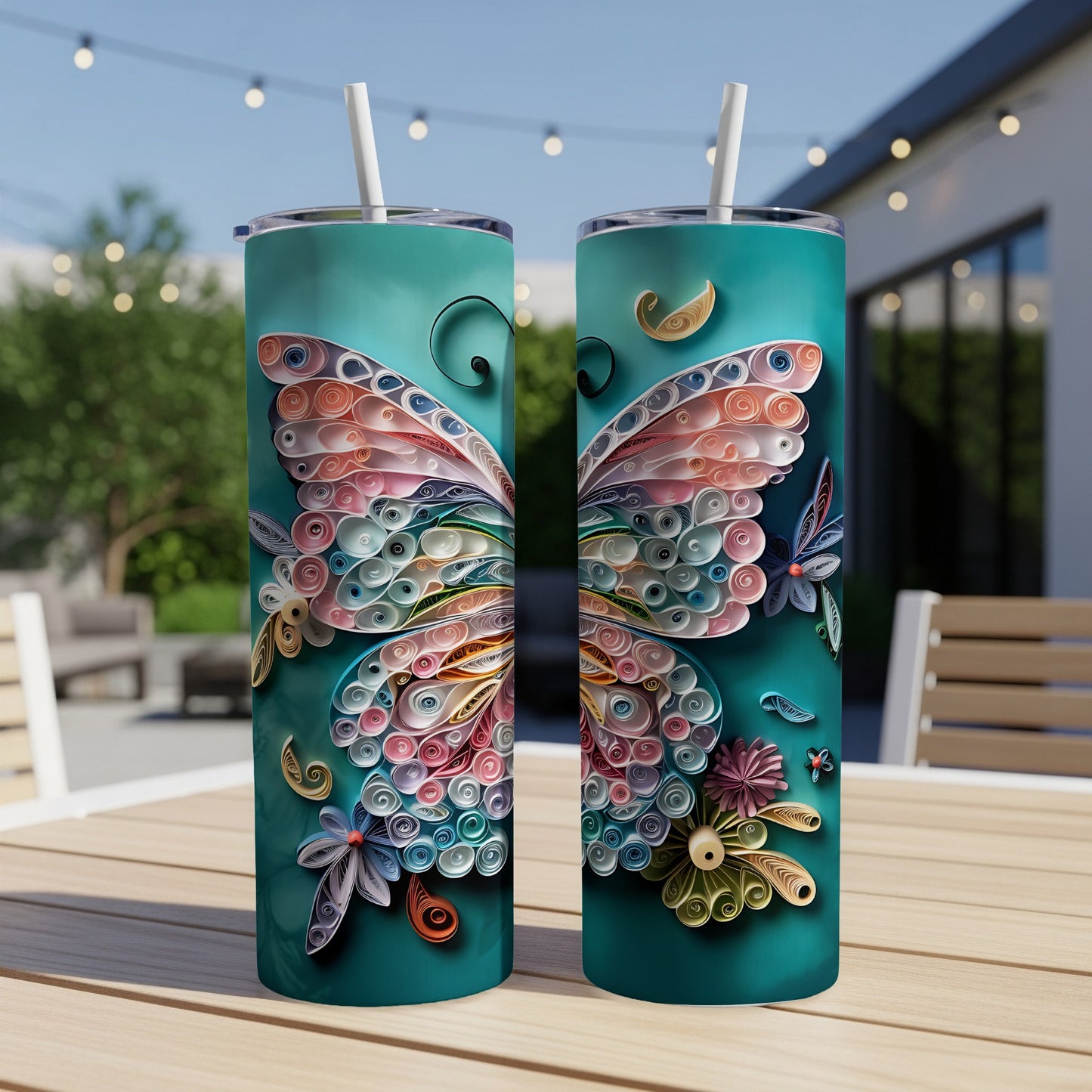 Teal tumblers with quilled butterfly and floral designs, featuring white straws.