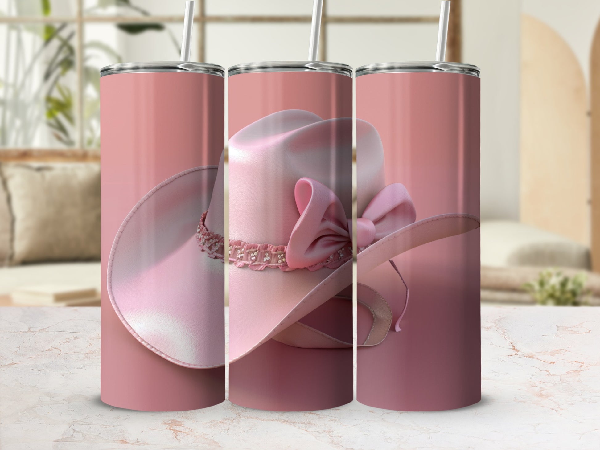 Pink cowboy hat tumbler with straw, featuring a bow and rhinestones.