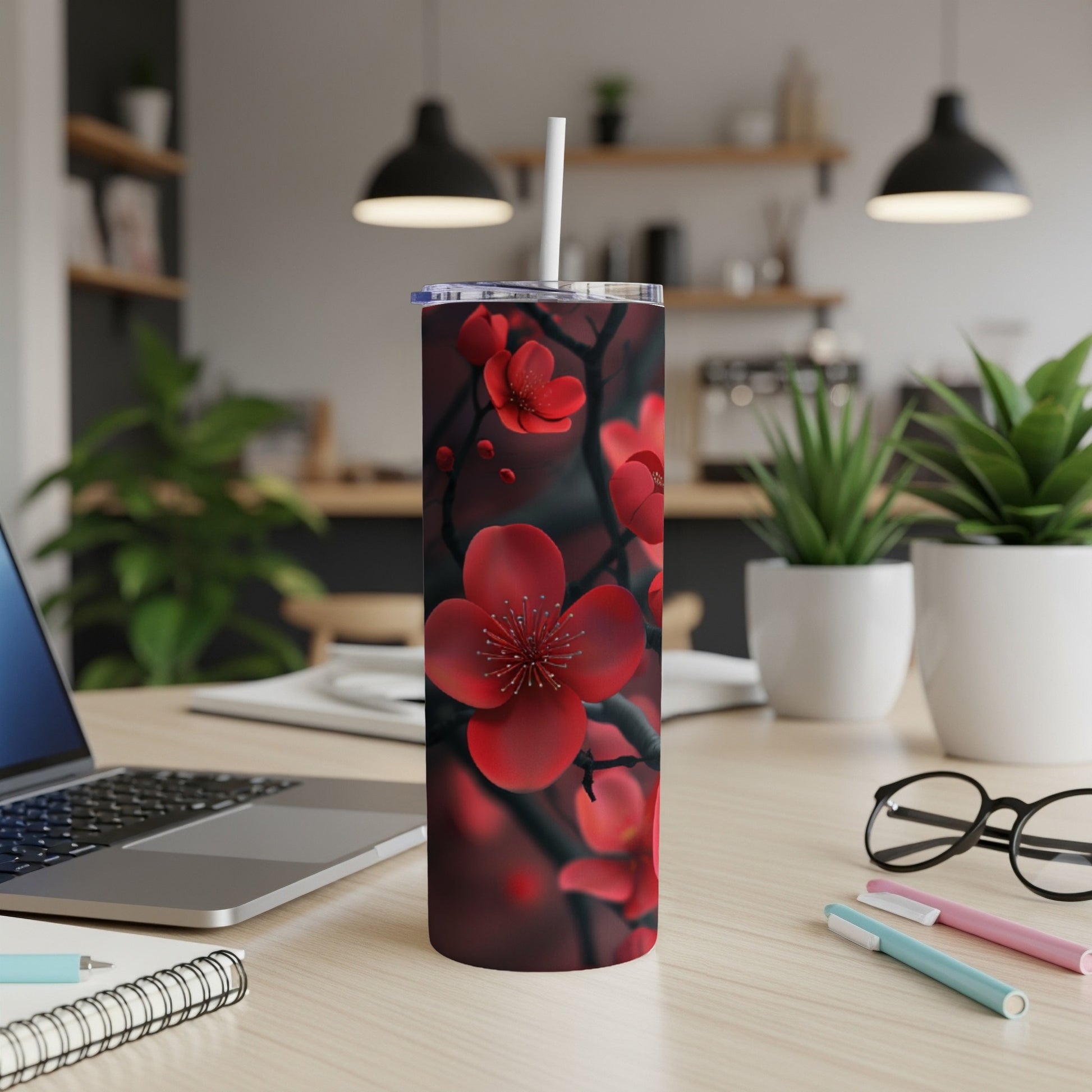 Red cherry blossoms on a dark background, depicted on a tumbler with a straw.