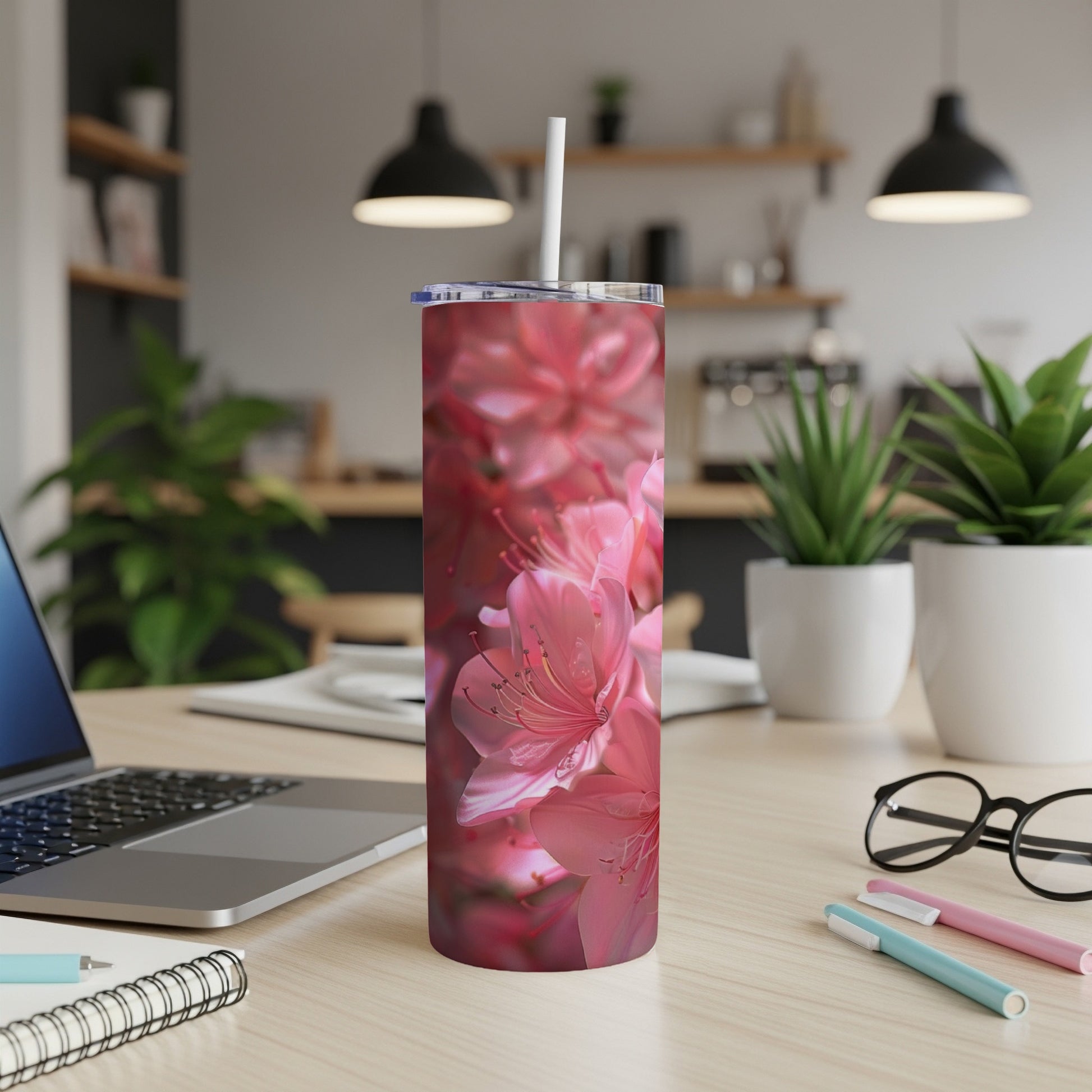 Pink floral pattern on a stainless steel tumbler with straw.