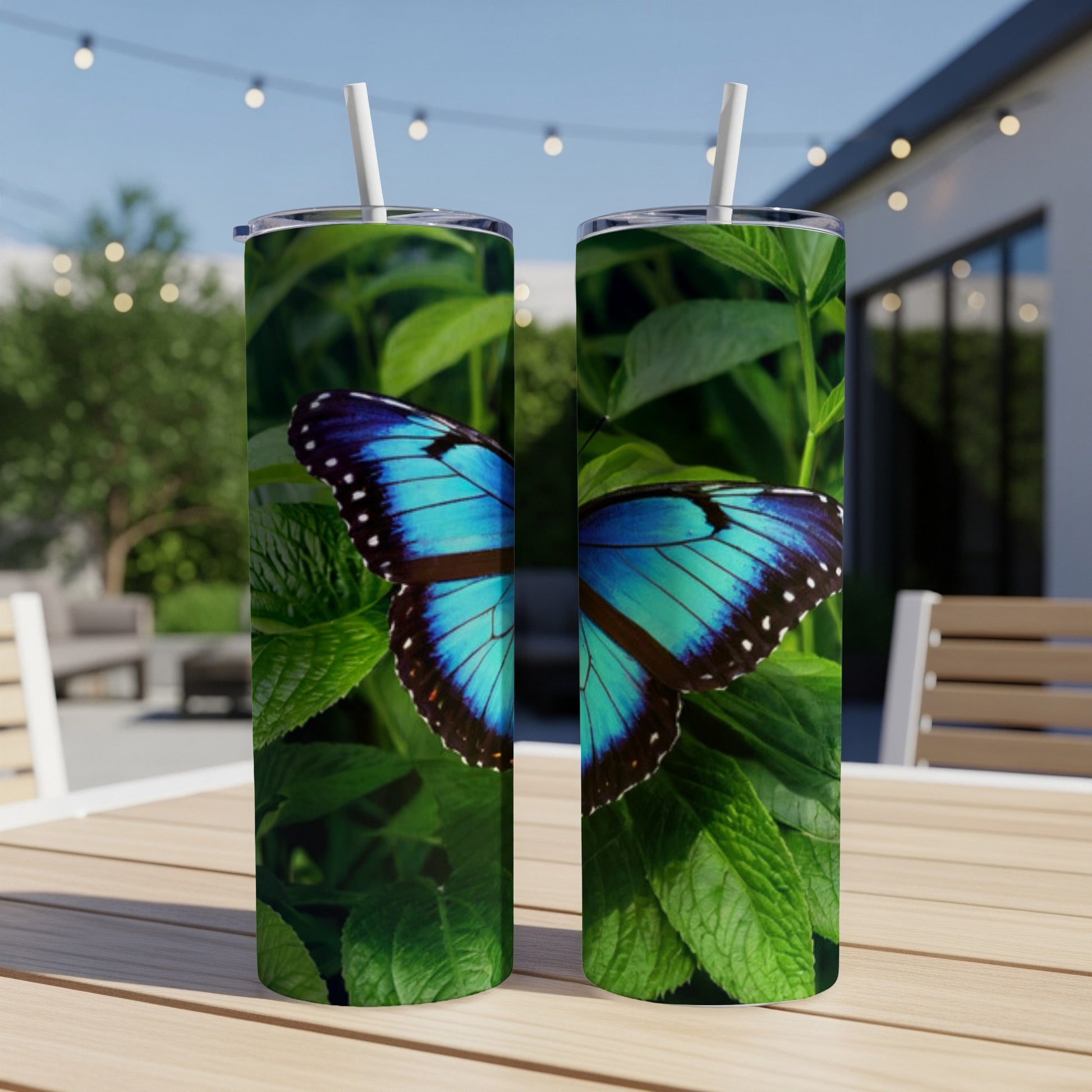 Two tumblers featuring a vibrant blue morpho butterfly on green leaves.