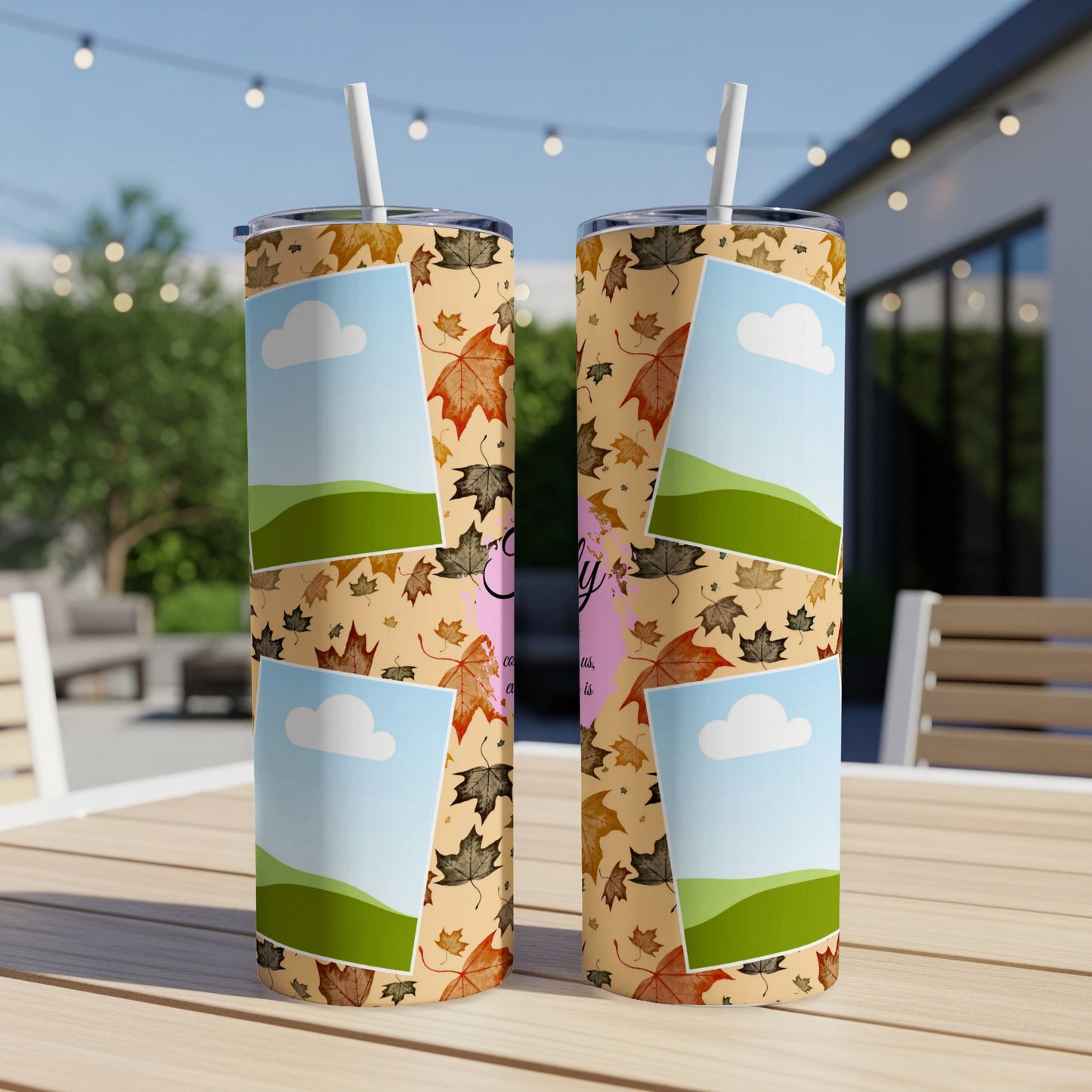 Two tumblers with fall leaves and photo frames featuring clouds and hills.