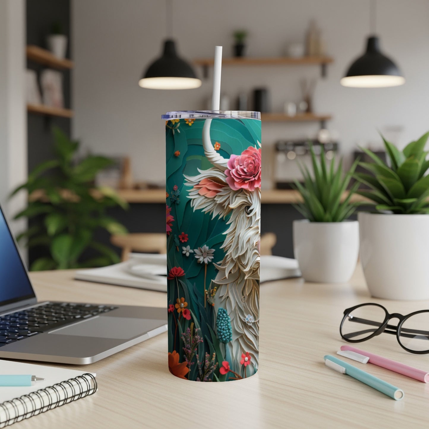 Highland cow illustration on a teal tumbler with flowers and leaves.
