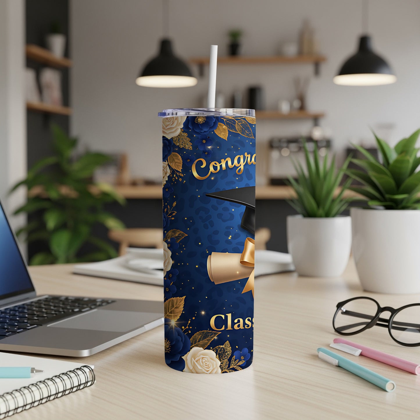 Graduation tumbler with diploma and floral design.
