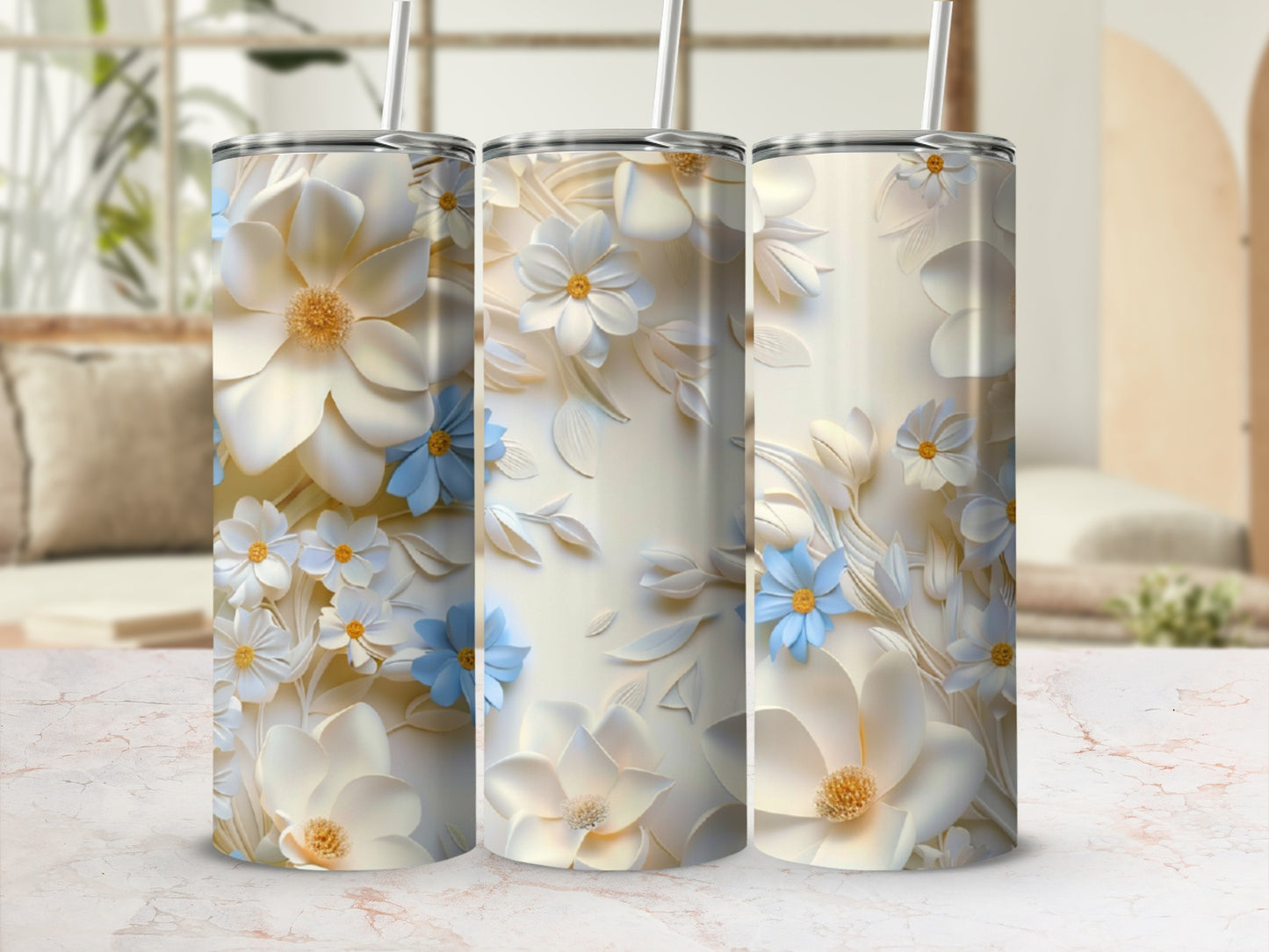 Three cream tumblers with embossed floral designs in white, cream, and blue.