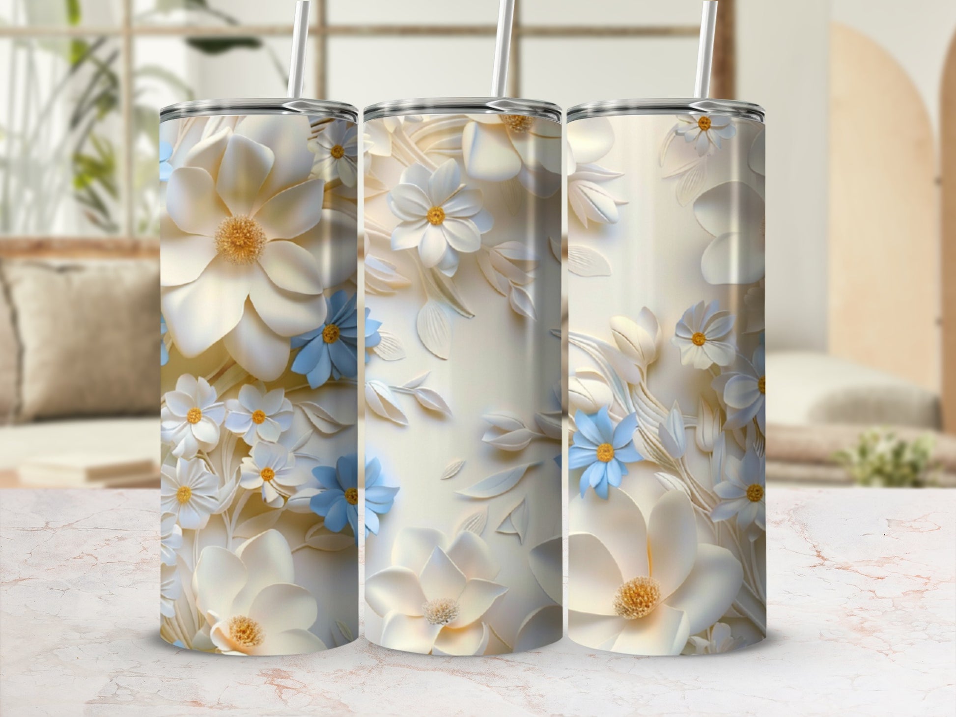 Three cream tumblers with embossed floral designs in white, cream, and blue.