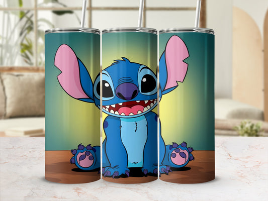 Blue Stitch character with large ears sits smiling on a wooden surface.