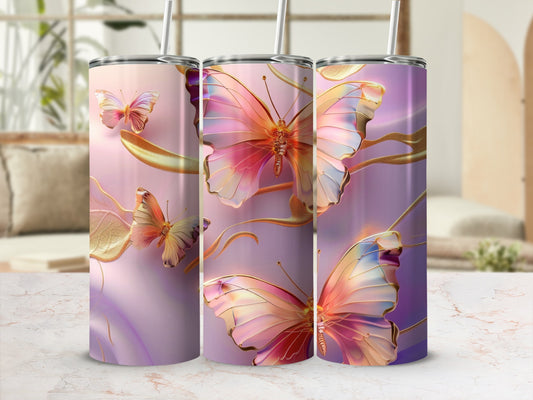 Three tumblers with iridescent butterflies and gold accents on a marbled surface.