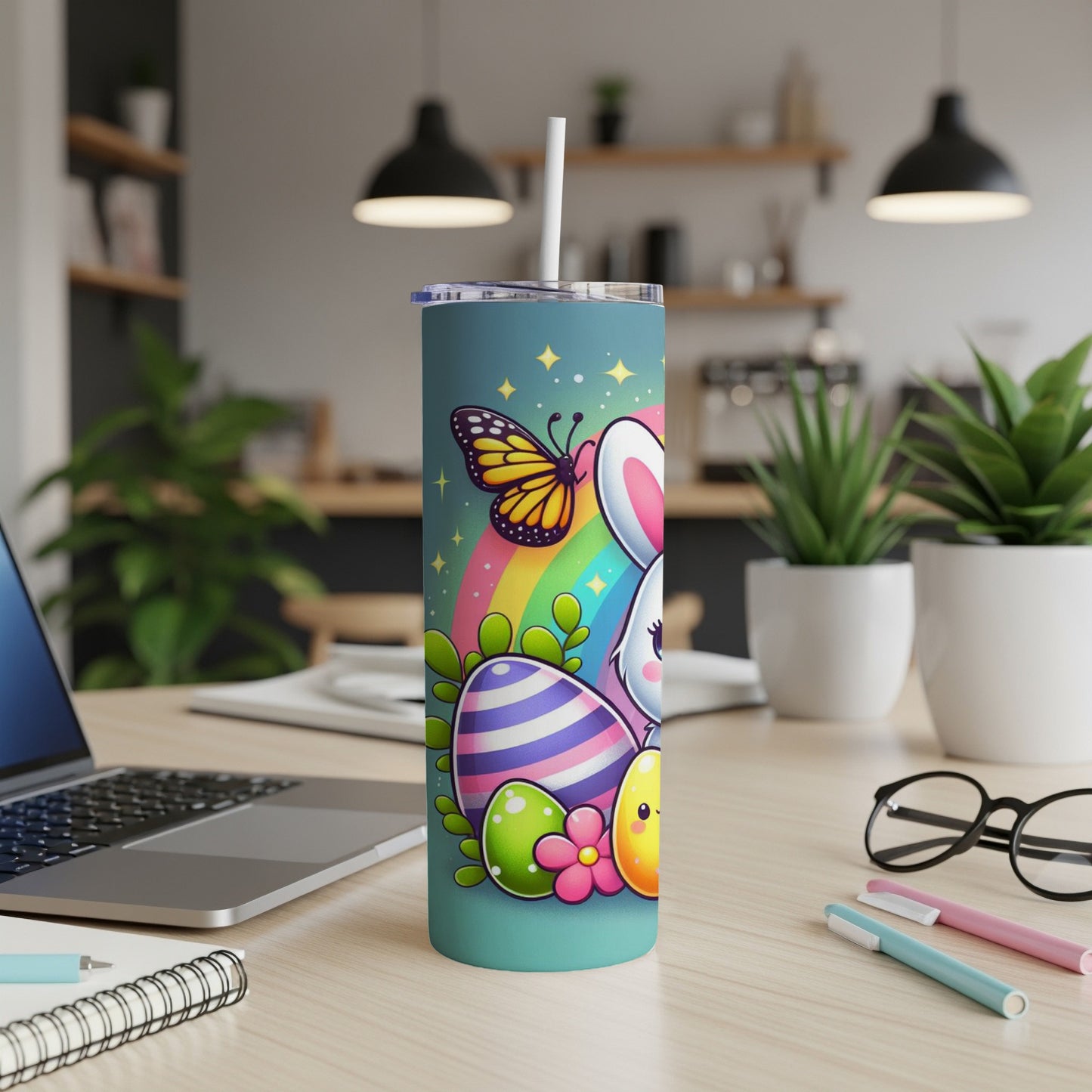 Easter bunny, eggs, and butterfly on rainbow over teal tumbler with straw.