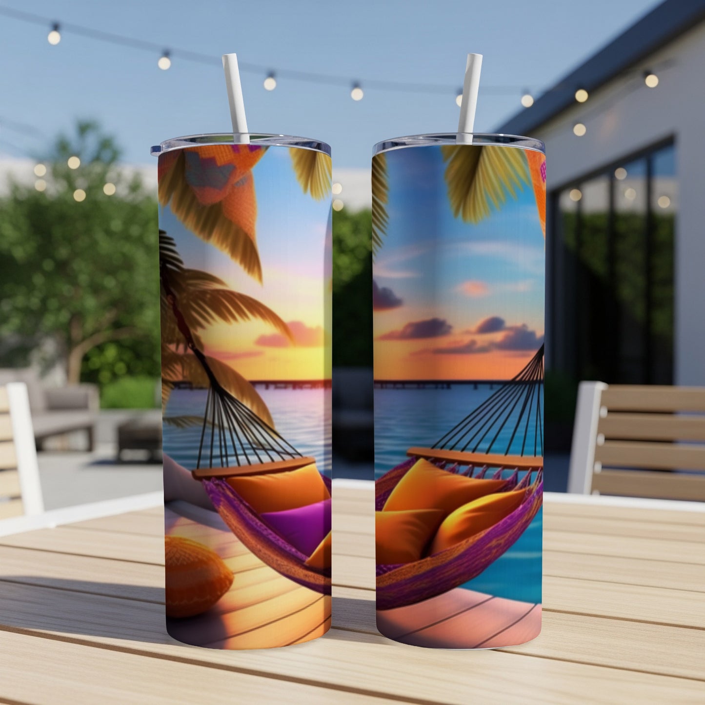 Two tumblers with a sunset hammock scene on a wooden table.