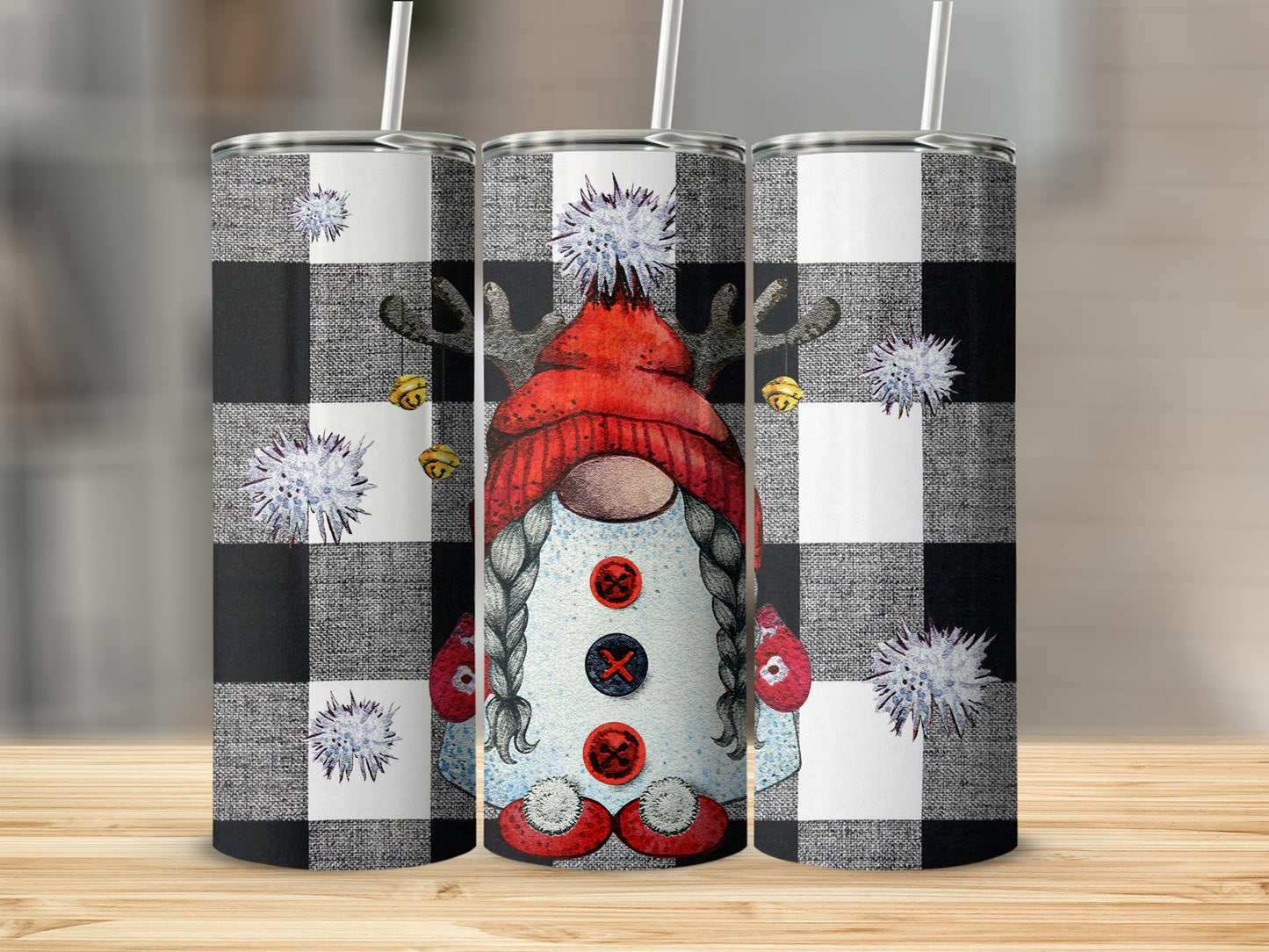 Three tumblers with a gnome design on a black and white buffalo plaid background.