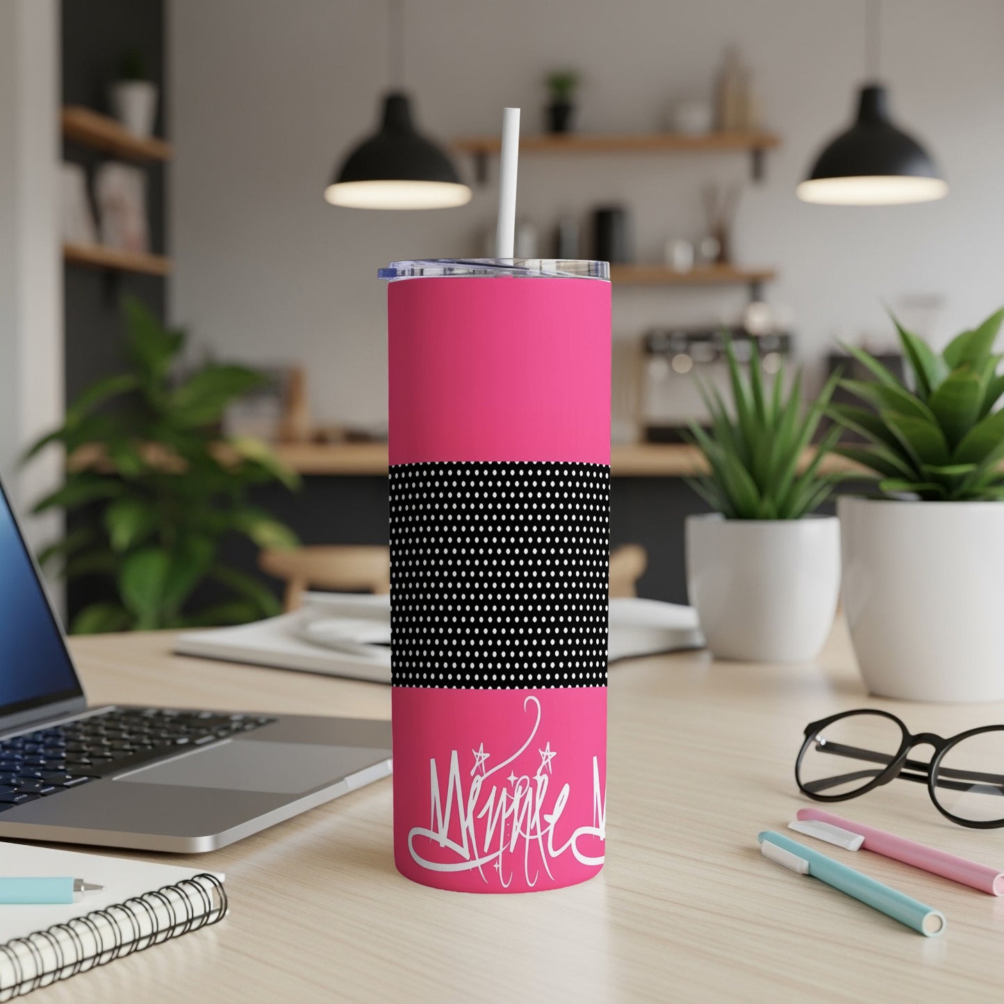 Bright pink tumbler with white handwritten text and black and white polka dot band.