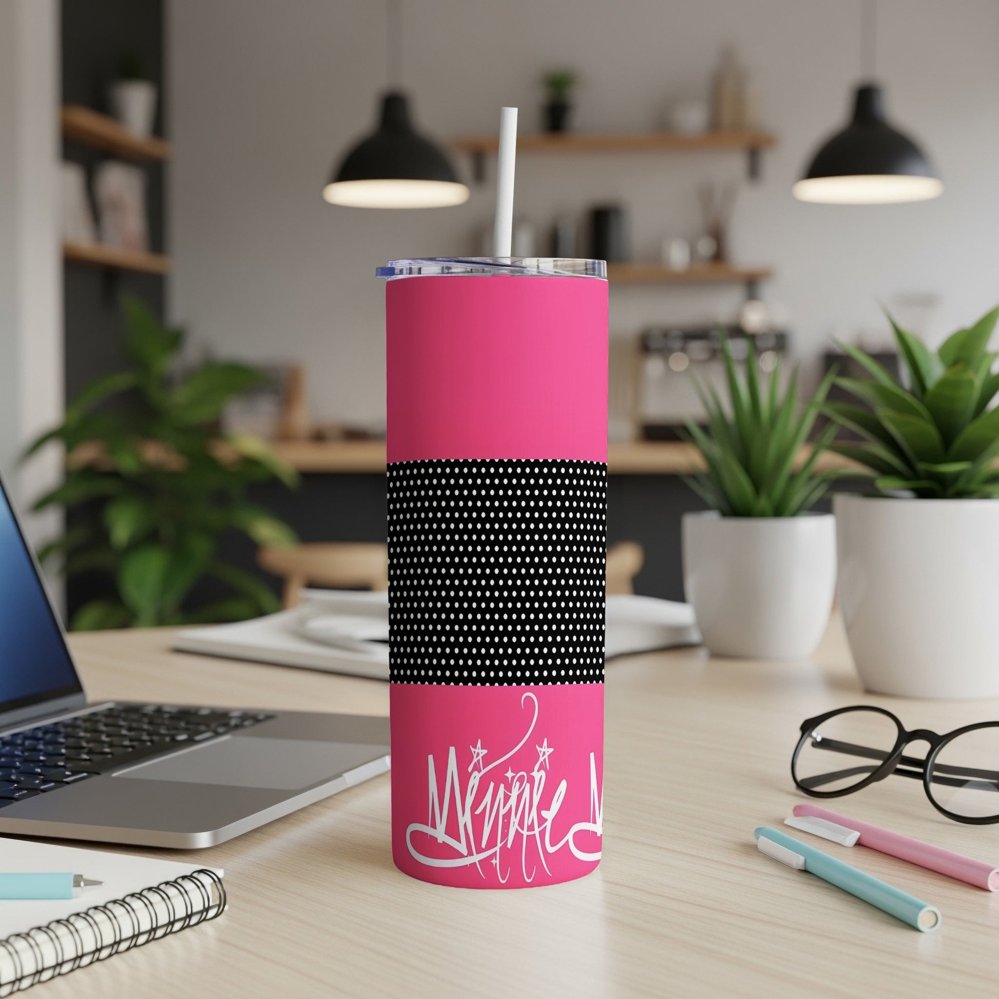 Bright pink tumbler with white handwritten text and black and white polka dot band.