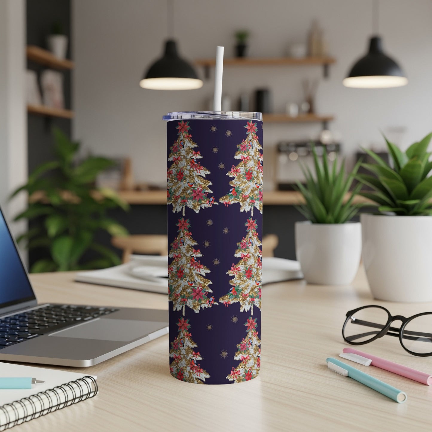 Tumbler with festive Christmas tree pattern and gold stars on dark blue background.