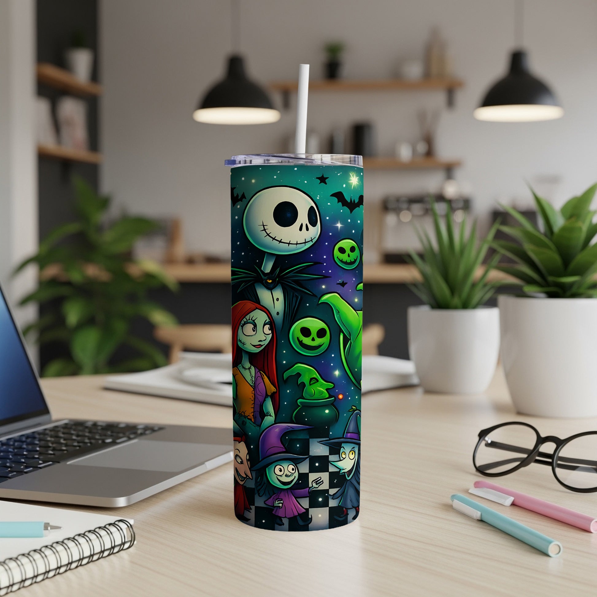 Tim Burton characters on a teal tumbler with Halloween motifs.