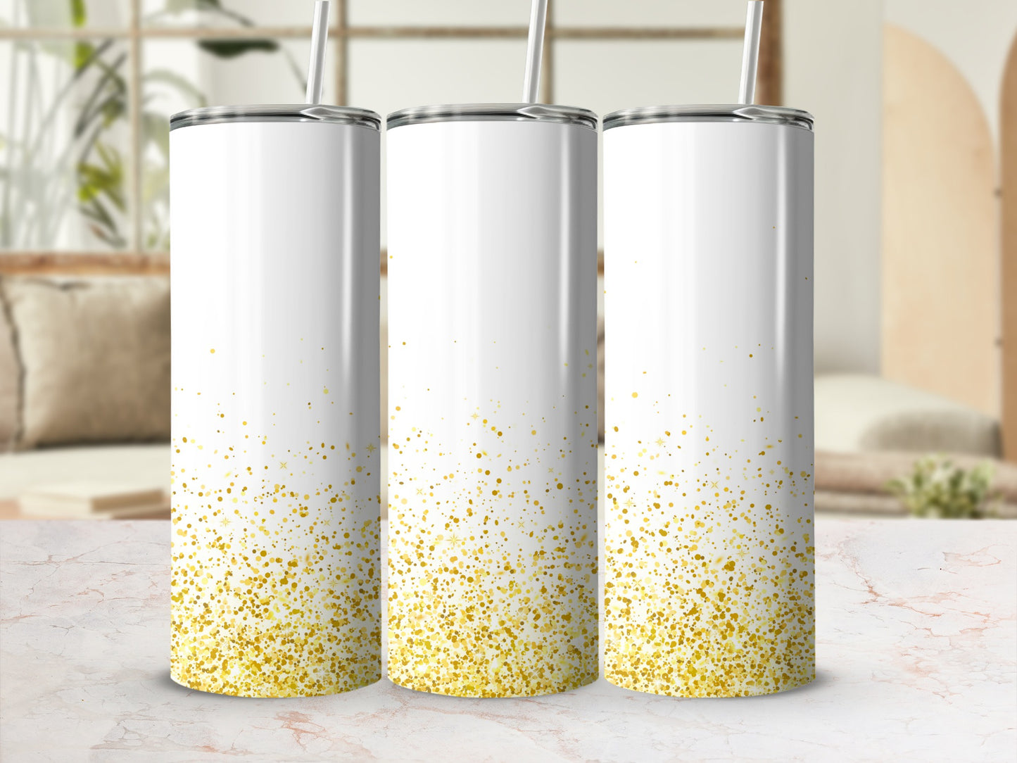 Three white tumblers with gold glitter accents stand on a marble surface.