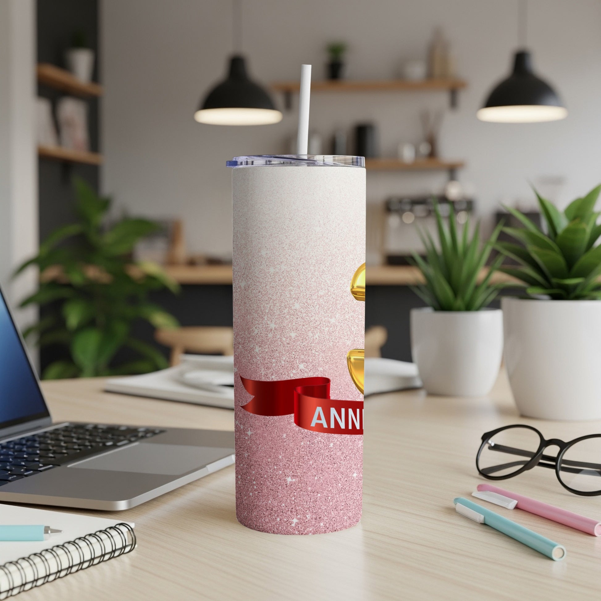 Pink glitter tumbler with gold "25th ANNIVERSARY" text on a ribbon.